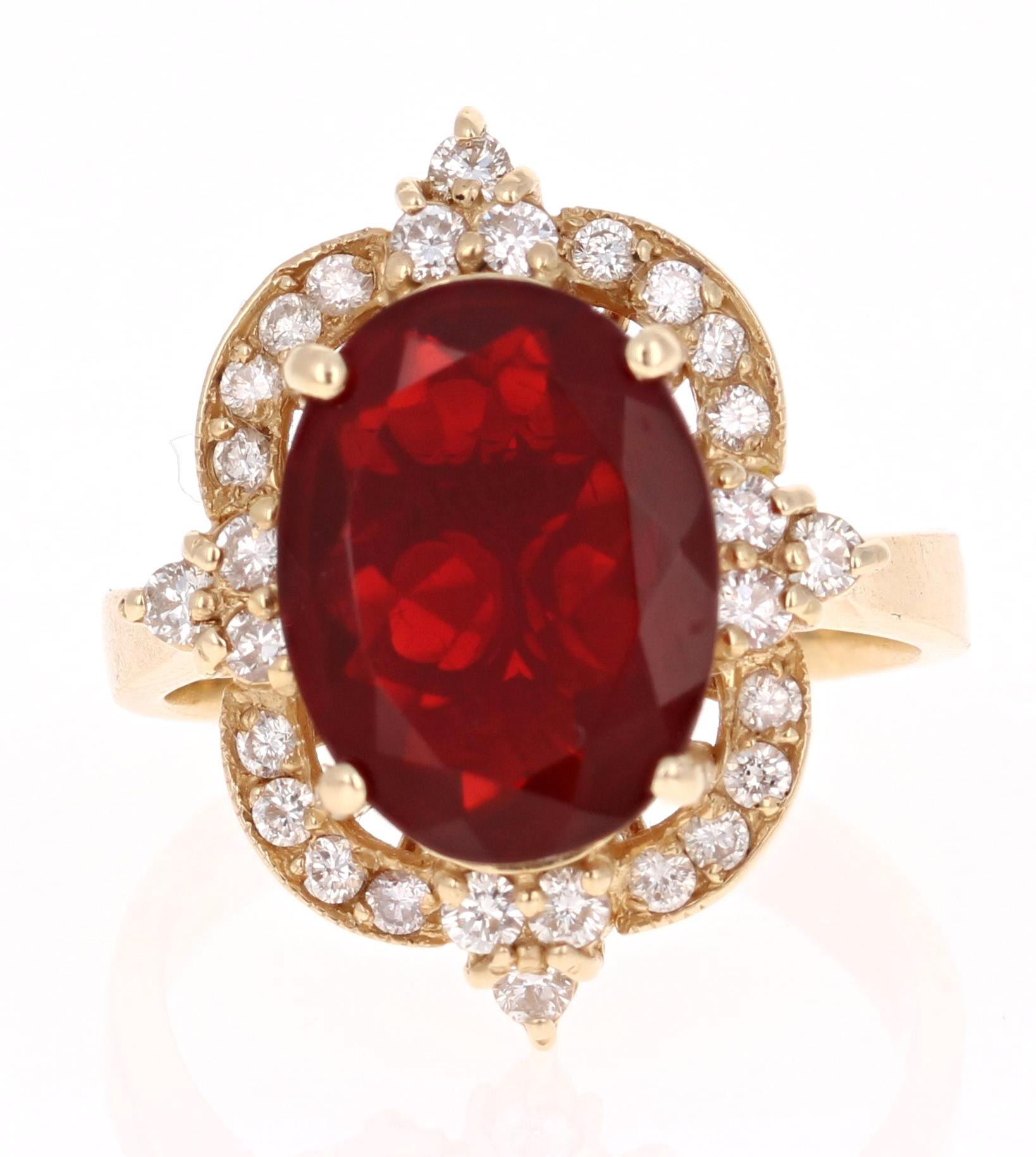This gorgeous cocktail ring has a beautiful deep red Oval Cut Fire Opal that weighs 3.11 Carats and 28 Round Cut Diamonds that weigh 0.54 Carats. The clarity and color of the diamonds are VS-H.  The total carat weight of the ring is 3.65 cts.  

It