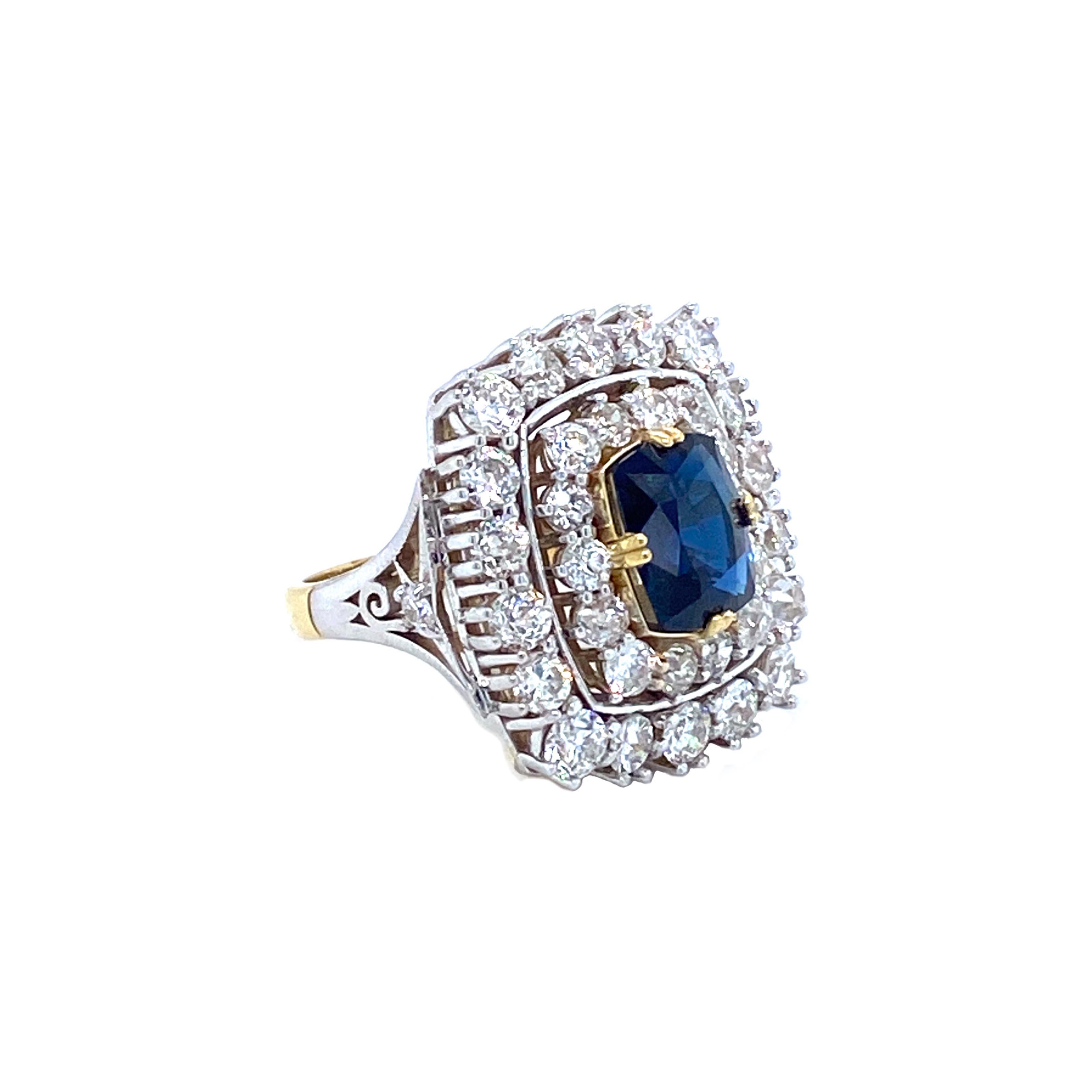 Offered here is a impressive ladies sapphire and diamond cocktail ring set in 18kt two tone gold. The ring measures about 1” x 0.90” on top and the shank graduates down to 2.9 mm. The ring is a size 7, but can be sized. The ring is marked 18k and