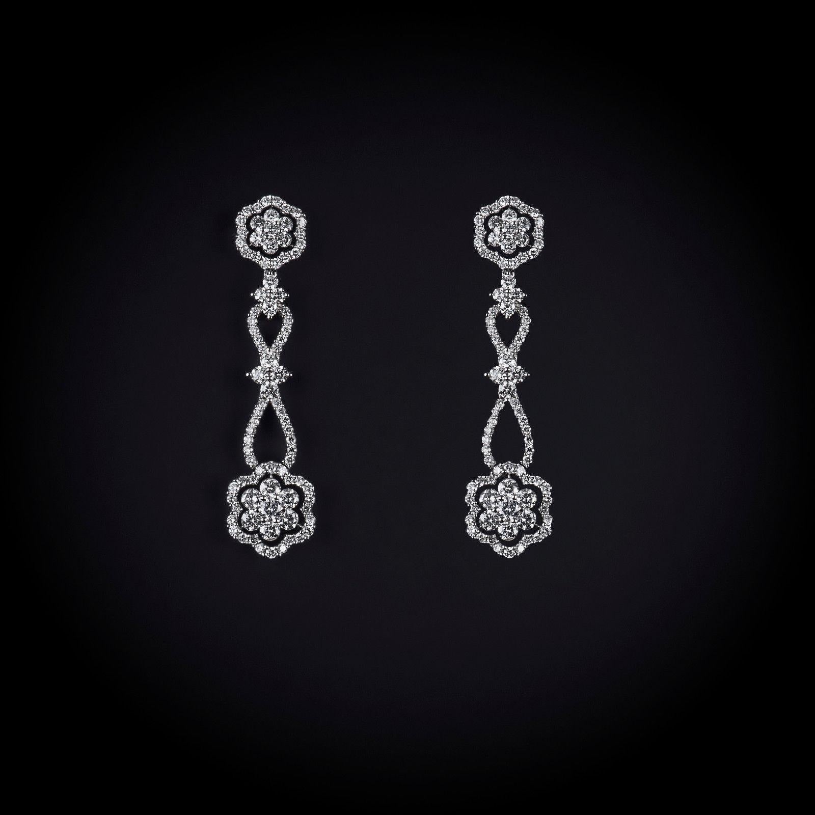 Gorgeous custom floral design drop earrings with 3.65 carat total weight of fine round brilliant diamonds set with 18K white gold.
The earrings are set with 76 prong set round diamonds that weight 3.65 carats total.
Color:F-H
Clarity: SI2-I1
The