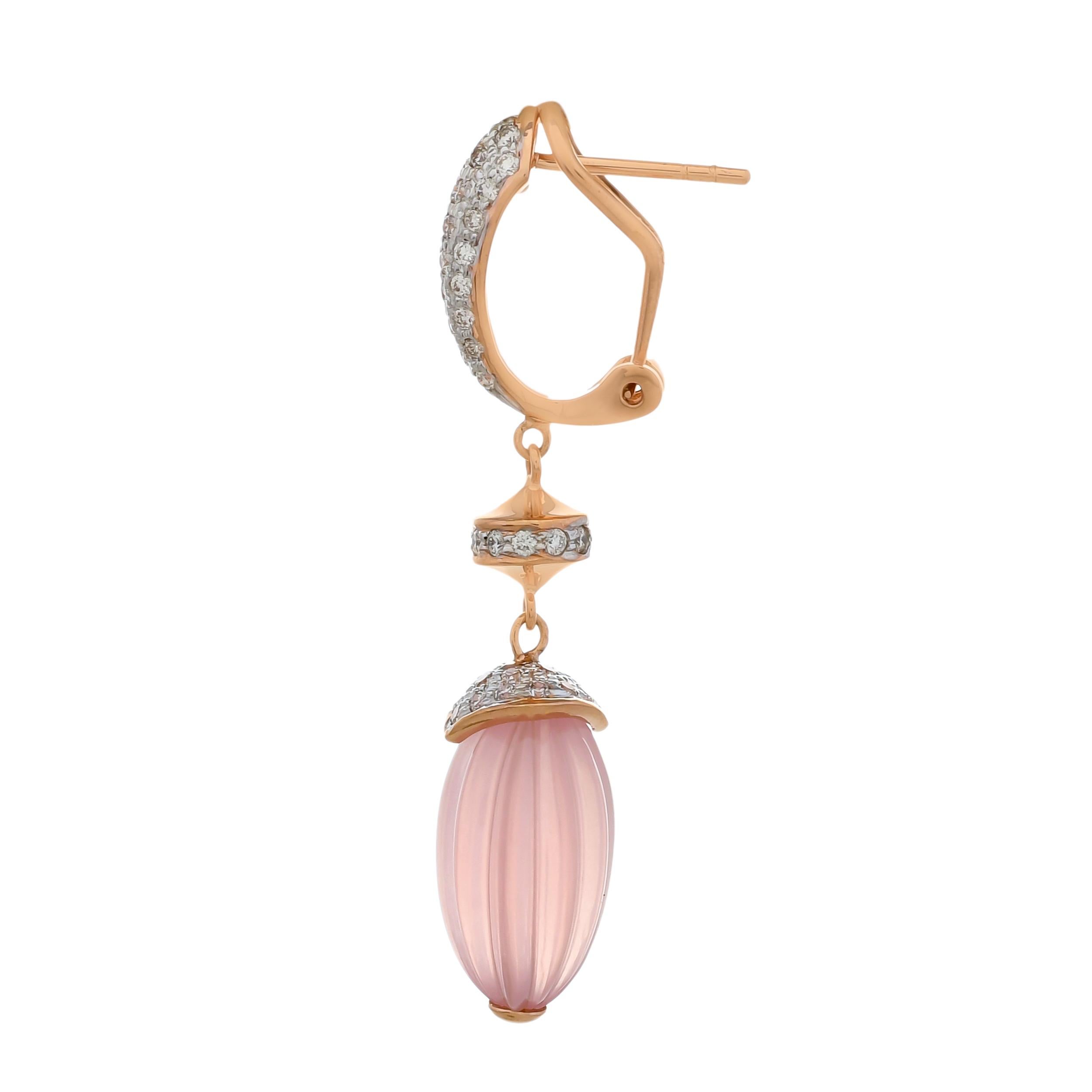 Fine luxury gets an avant garde lift through these stunning drop earrings crafted with pastel hues of hand carved rose quartz melons weighing approximately 36.52 carats and gleaming glow of diamonds with a total diamond weight of 1.65 carats. These