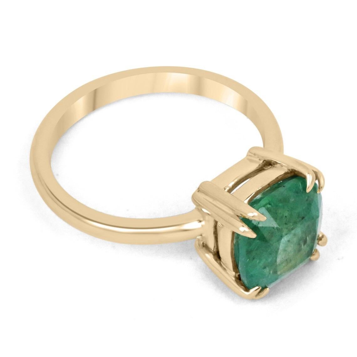 Displayed is a classic emerald solitaire, cushion-cut, engagement ring/right-hand ring in 14K yellow gold. This gorgeous solitaire ring carries a full 3.65-carat emerald in a double claw prong setting. Fully faceted, this gemstone showcases