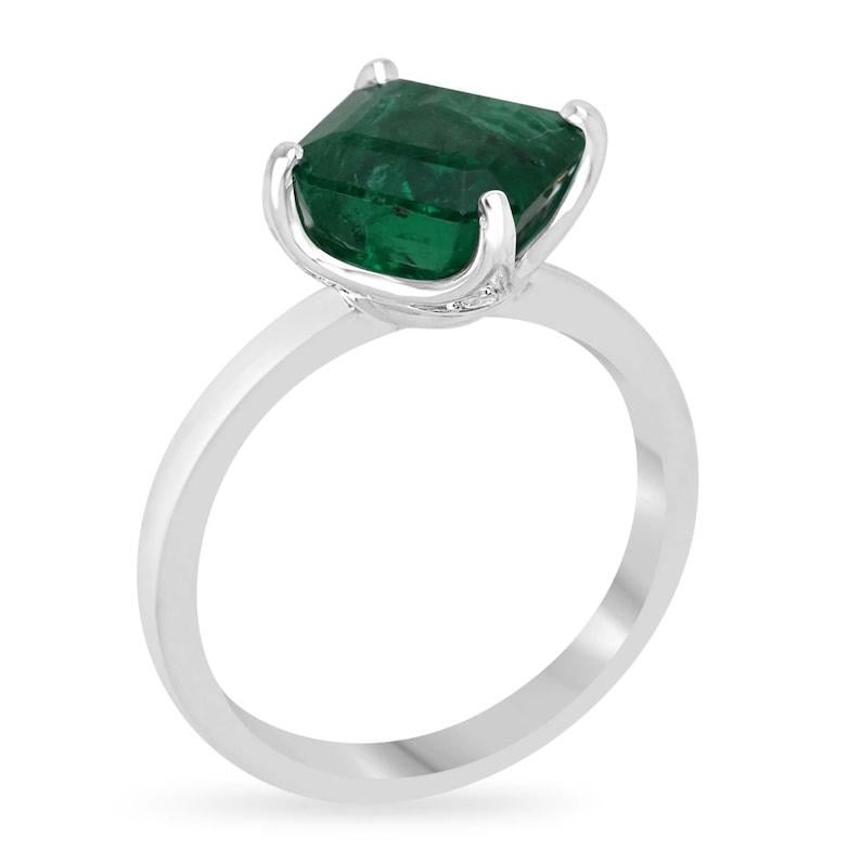 Indulge in elegance with our Emerald Diamond Accent Ring, featuring a captivating 8x8mm Asscher cut emerald, radiating rich green hues and semi-transparent clarity. Set in a luxurious four-prong off-set white gold setting crafted in 14k, this ring