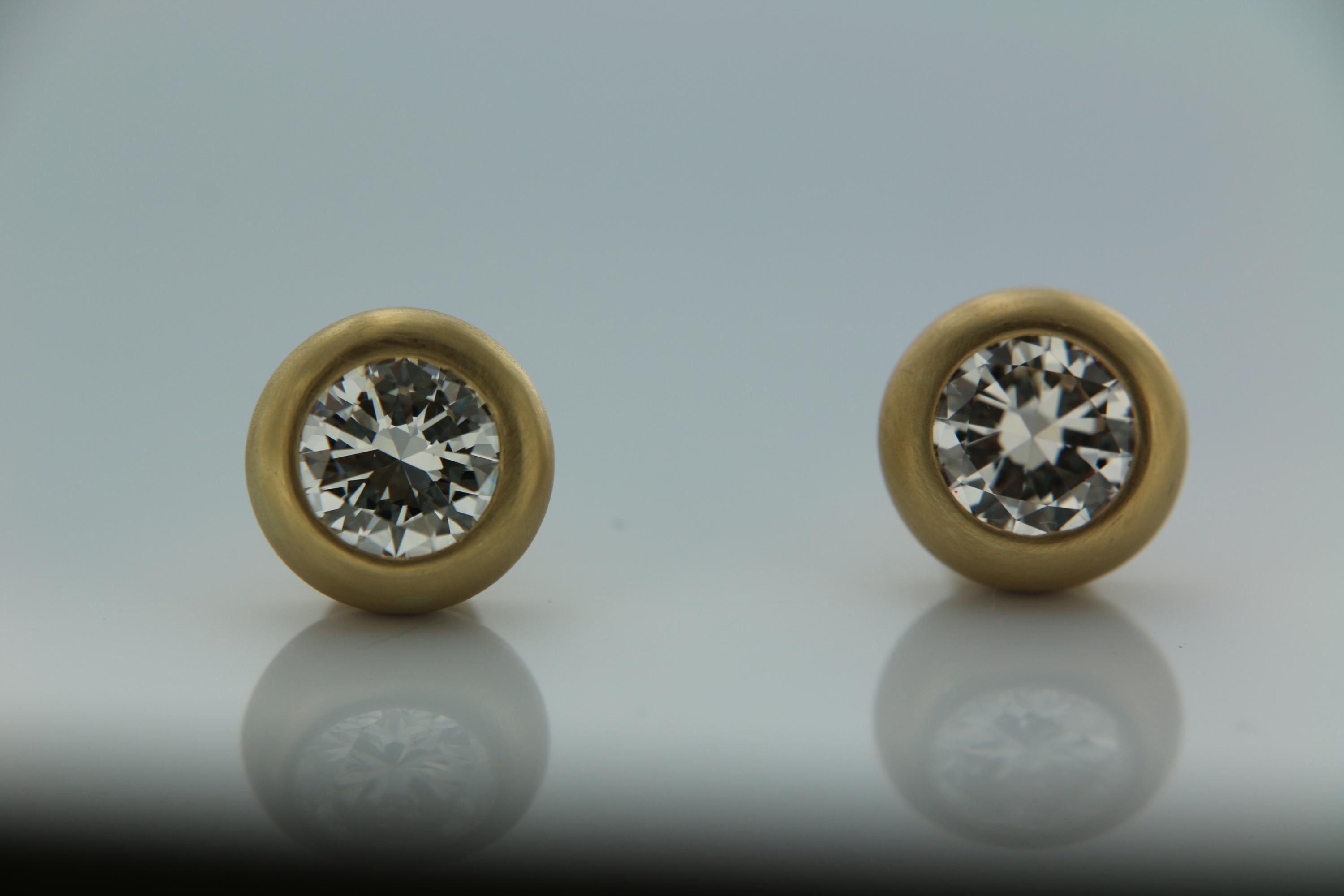Classic and elegant solitaire stud earrings features two white round brilliant diamonds weighing  1.88 carat  and 1.78carat ( 3.66 carat ) with I color and VS clarity. These are hand crafted and bezel set with open back in 18K brushed yellow gold.