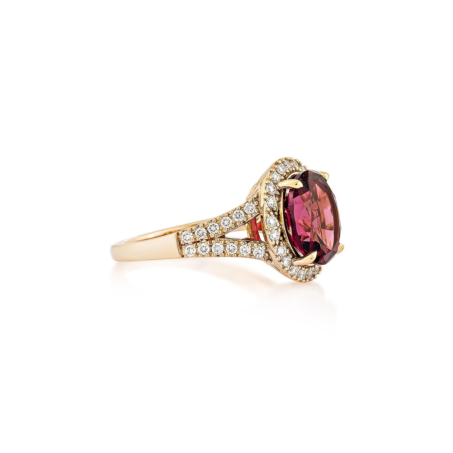 Sunita Nahata presents an elegant Rhodolite fancy ring in an oval shape, set with sparkling white diamonds. This exquisite piece exudes grace and elegance, making it perfect for both daily wear and special occasions. Crafted from 18-karat rose gold,