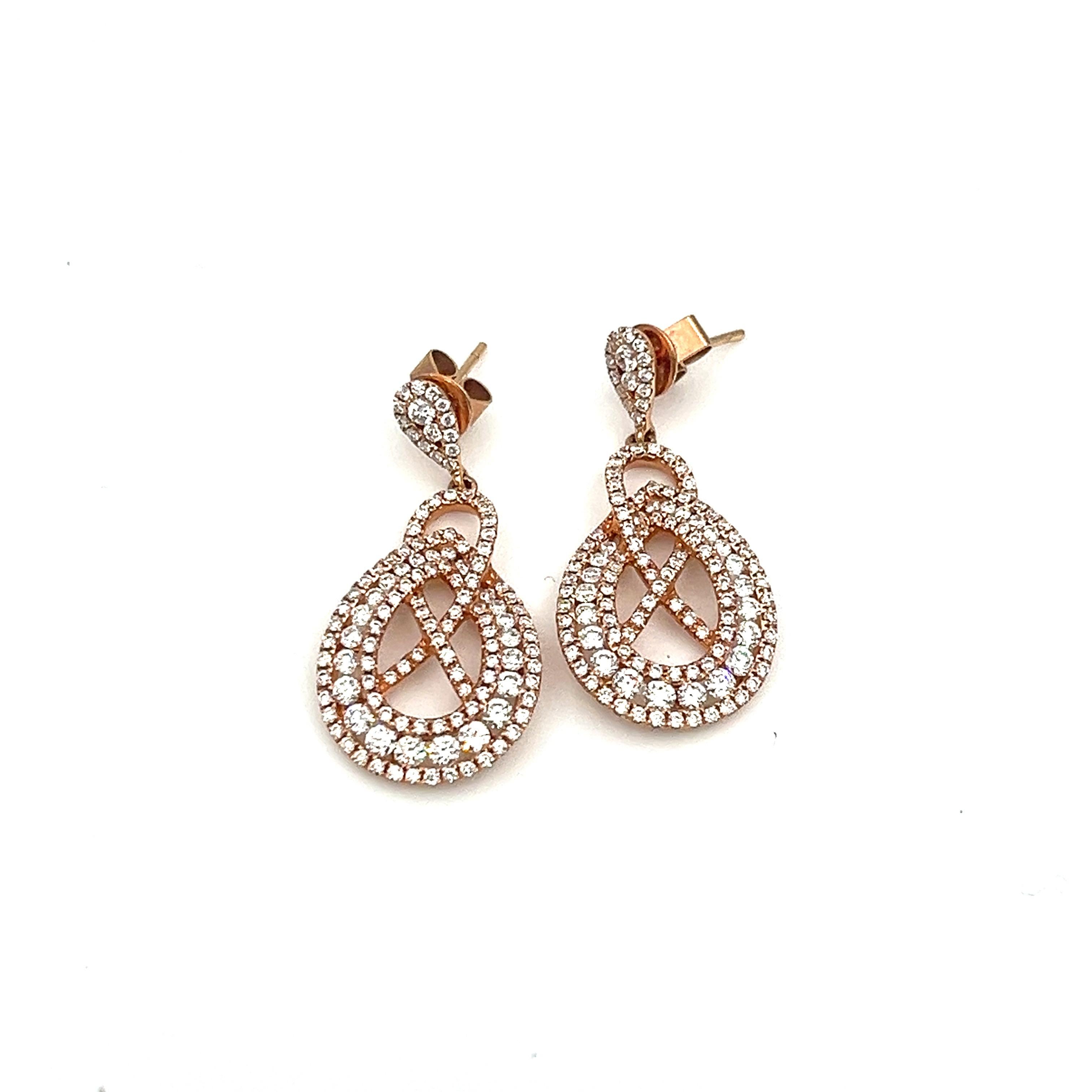 These stunning 18k rose gold dangle earrings with 256 diamonds are sure to turn heads. The diamonds are graded E/F with a clarity of VS1/VS2. A great addition to any wardrobe. 
