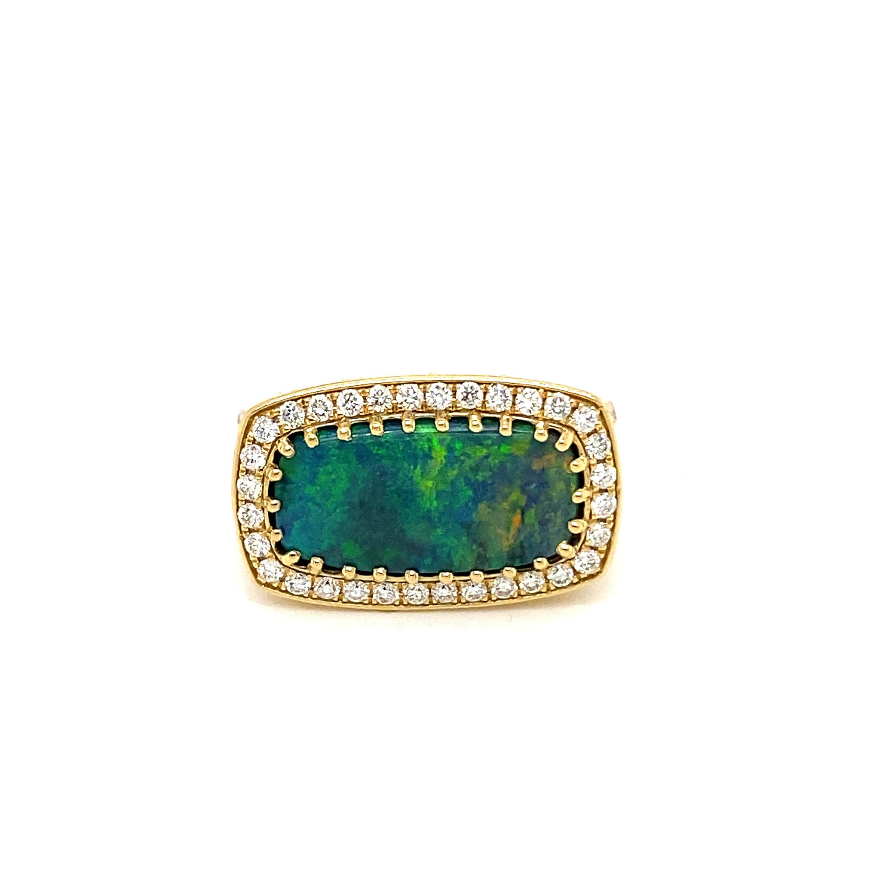 This stunning cocktail ring showcases a beautiful 3.67 Carat Lightning Ridge Cushion Black Opal with a Diamond Halo on a Diamond Shank. This ring is set in 18k Yellow Gold, with 18k yellow gold prongs on the center stone.
Total Diamond Weight = 0.78