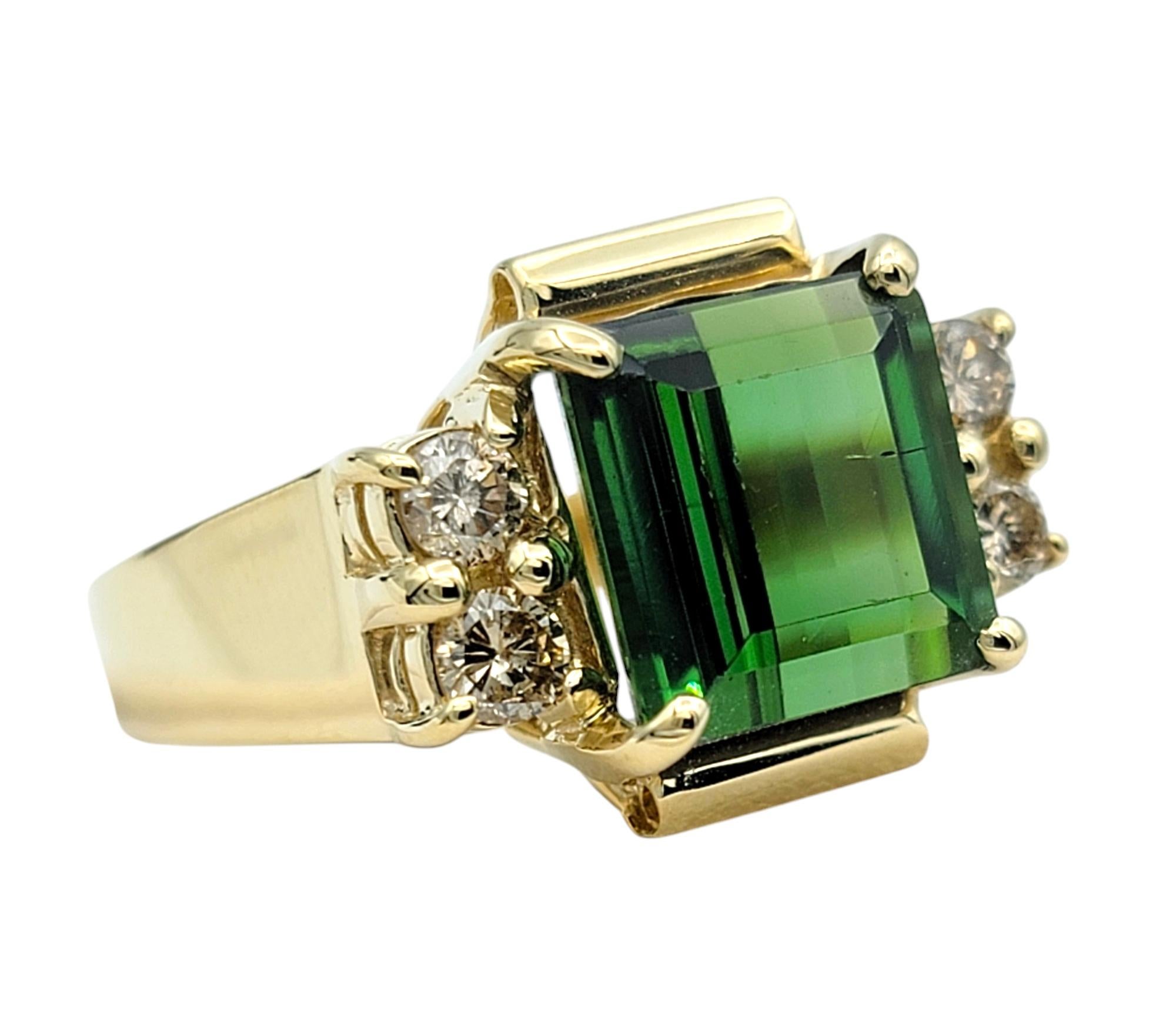Ring Size: 6.5

Step into sophistication with this stunning ring, a true testament to refined artistry and timeless design. At its center, a square modified brilliant cut green tourmaline commands attention with its captivating depth and radiant