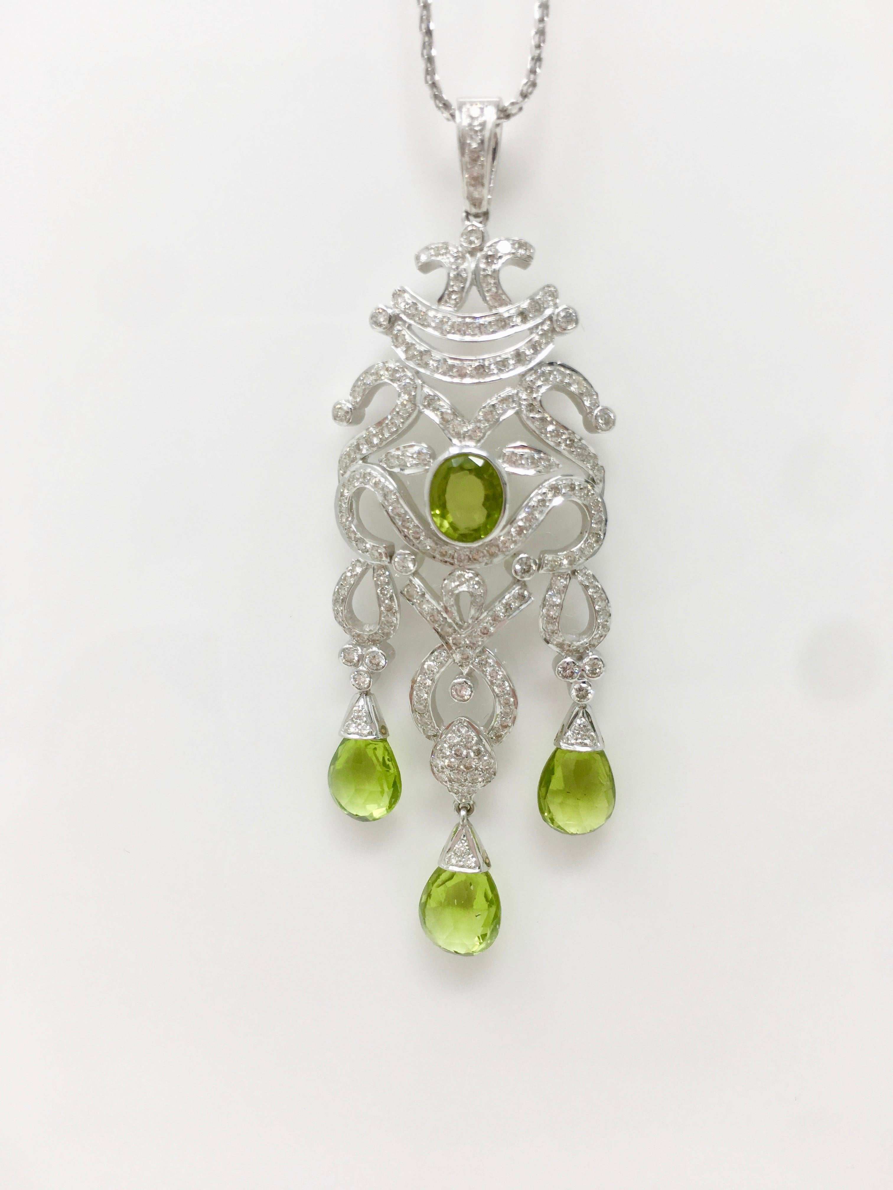 This unique elegant creation by Moguldiam Inc features a beautifully custom handmade pair of earrings  and a gorgeous pendant weighing 3.67 carat  white round brilliant diamonds with GH color VS clarity and 17.45 carat green peridot. The measurement