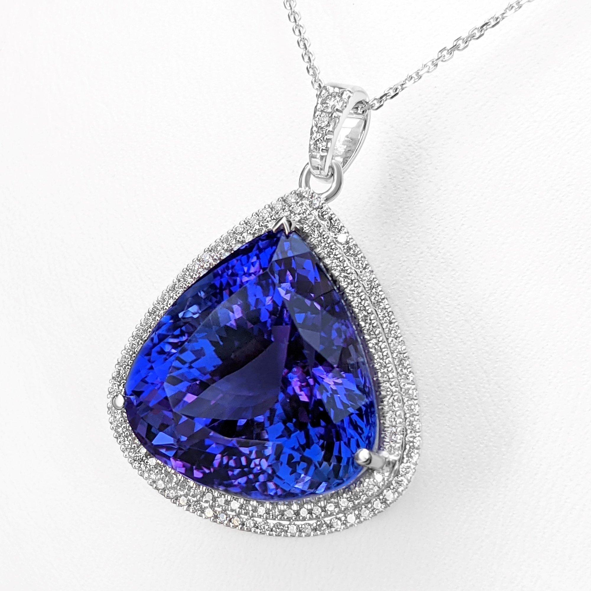 18 kt. White gold
Necklace with pendant
Size: 40 cm 
Total weight: 15.42 g (gold + stones)

Center Tanzanite Stone:
Weight:  36.78 cttw
Color: Violetish blue
Shape: Pear Mixed
Gemstones are commonly treated to enhance colour or clarity. This has not