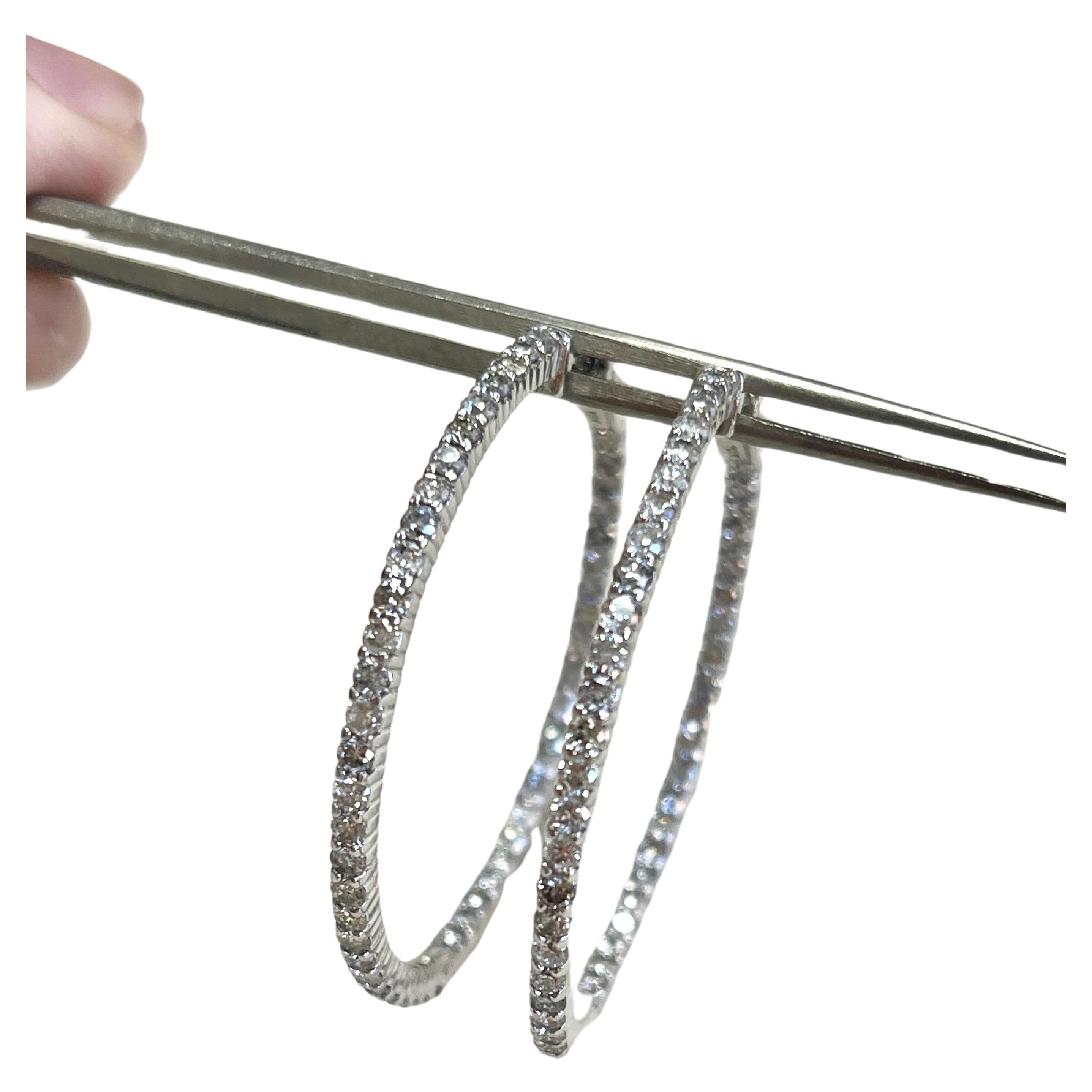 Beautiful pair of diamond hoop earrings in 14k white gold. Secures with snap closure for wear. Elegance for every moment. Inside out style 100 pieces Natural Diamonds
Average Color F, Clarity  I 
Measures 1.70 inch diameter.  10.94 grams

*Free