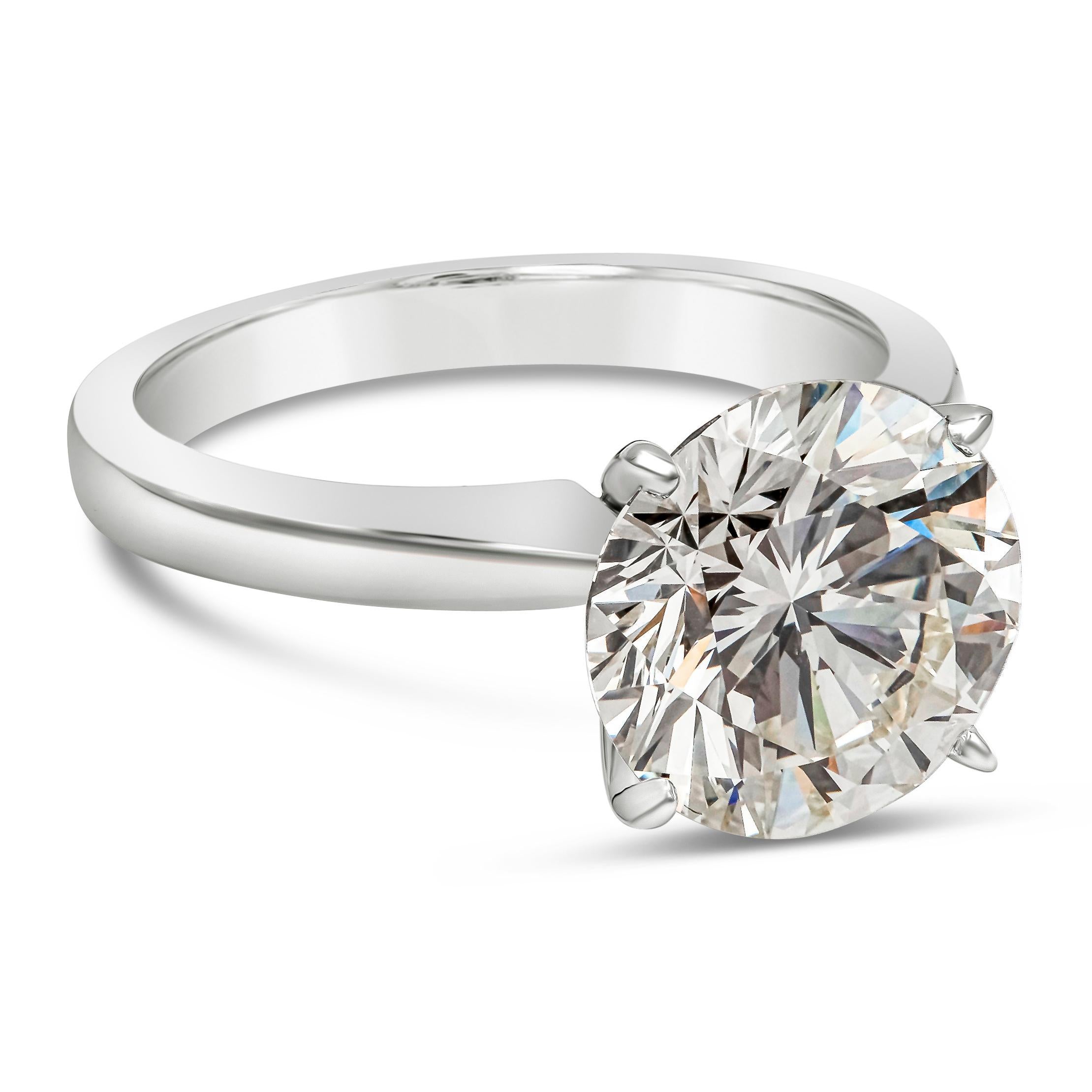 An elegant and classic solitaire engagement ring style, showcasing a round brilliant cut diamond weighing 3.68 carats certified by GIA as K color and VS2 clarity, set in a four prong basket setting of 18K white gold. Size 6 US, resizable upon