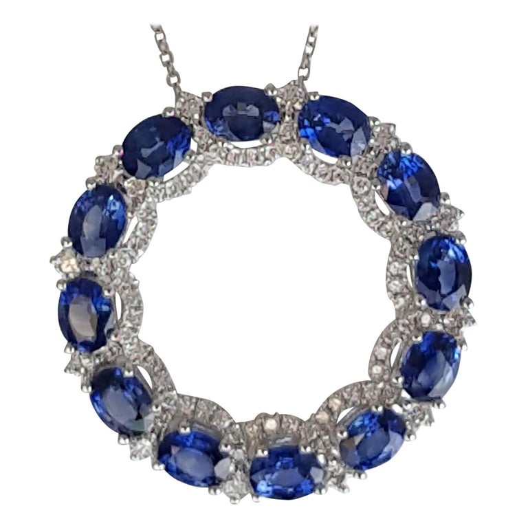 This beautiful sapphire pendant features twelve oval cut blue sapphires tucked among 72 round white diamonds, to form a round ring. The total sapphire weight is 3.68 carats, and the total diamond weight 0.53 carats.

Set in 18k White Gold

Diamond
