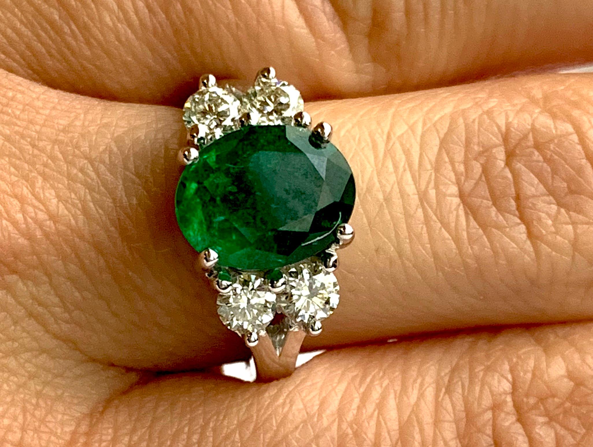 oval diamond with emerald side stones