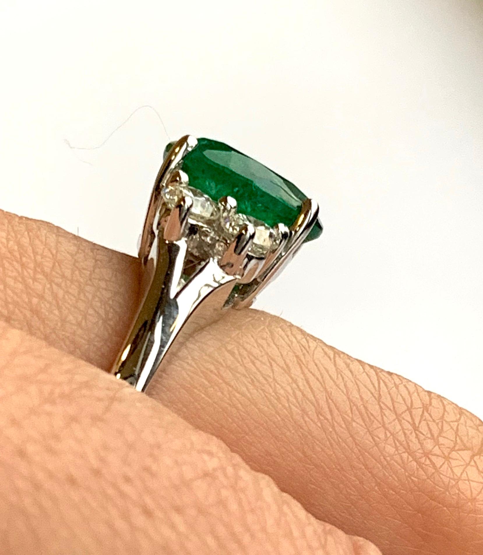 Oval Cut Oval Emerald and Diamond Side Stone Engagement Ring