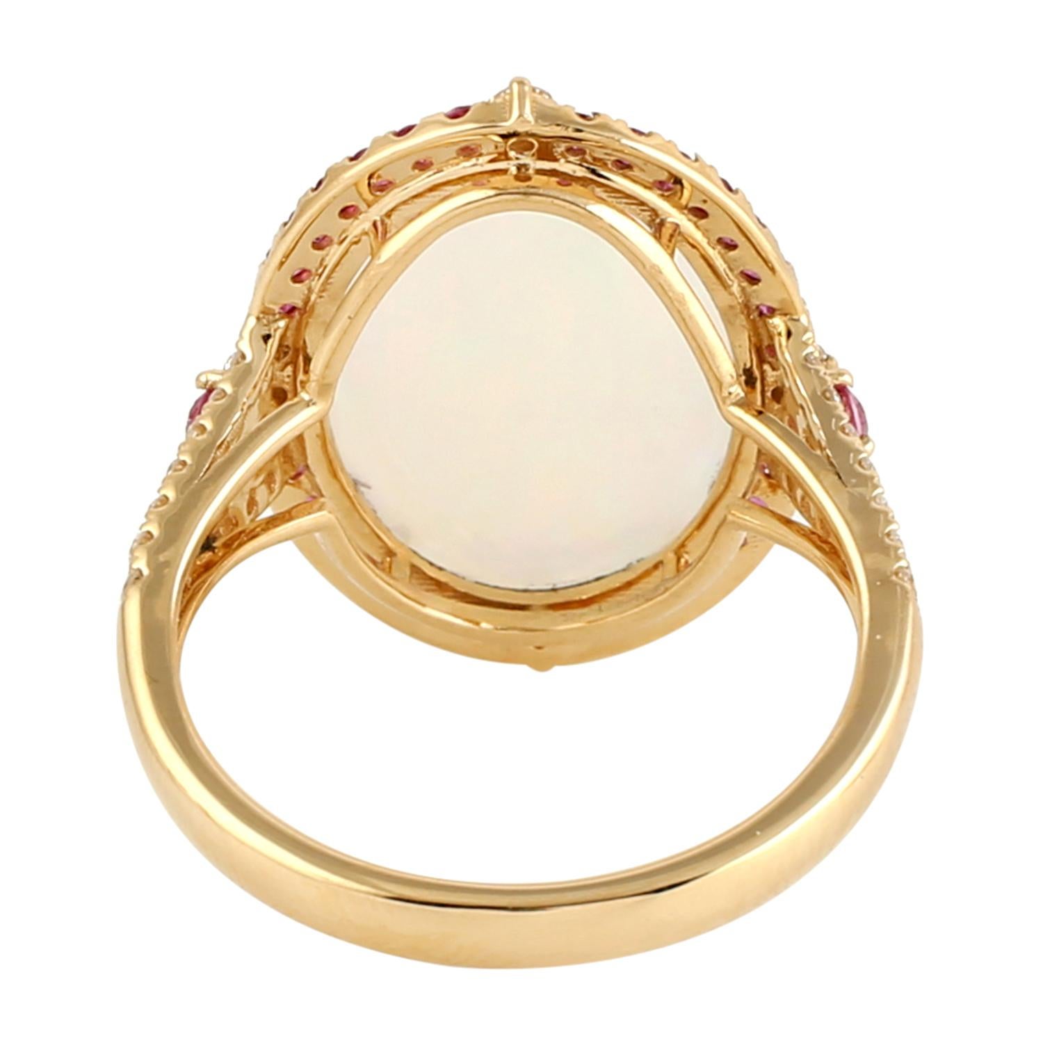 This ring has been meticulously crafted from 14-karat gold.  It is hand set with 3.68 carat Ethiopian opal, .55  carats pink sapphire & .25 carats of sparkling diamonds. 

The ring is a size 7 and may be resized to larger or smaller upon request.