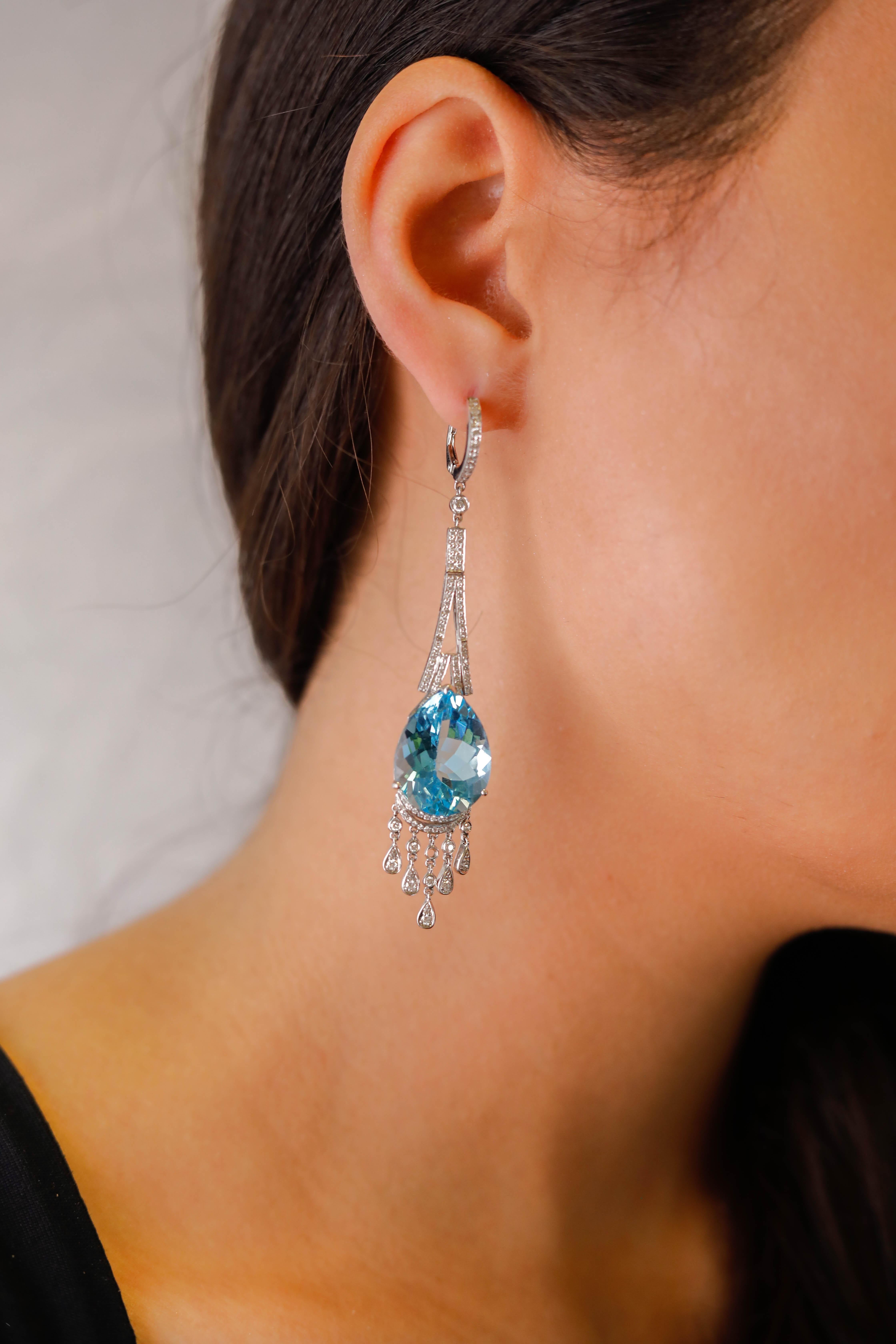  36.84 Carat Blue Topaz 1.07 Carat Diamond 18 Karat Gold Dangle Earrings Fine Jewelry 

Fashion in stunning 18k White Gold, these drop earrings show almost 37TCW of soft blue topaz dangling from a thread of 1 TCW round shimmering diamonds. A great