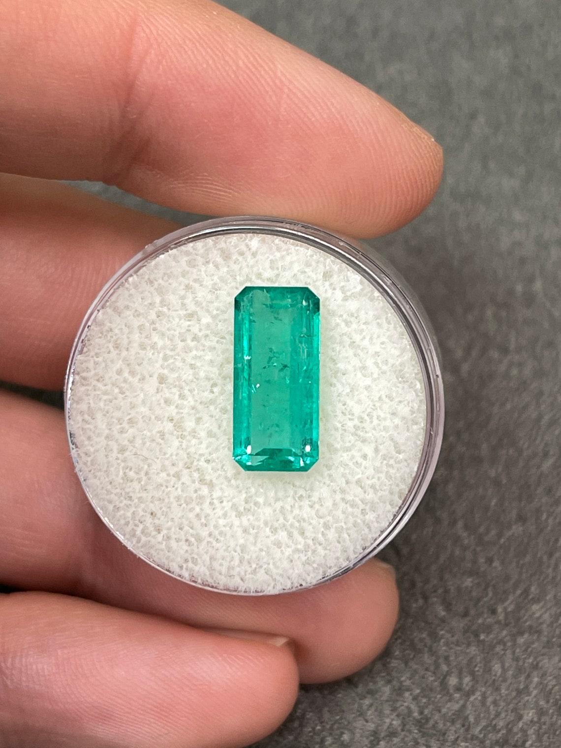 Stone: Emerald
Weight: 3.68-carats
Shape: Emerald Cut
Clarity: Transparent
Luster: Very Good
Color: Medium Bluish Green
Measurements: 13.75mm x 6.37mm
Geographic Origin: Colombia
Treatment: Natural, Oiling

Comments: Due to their growth conditions