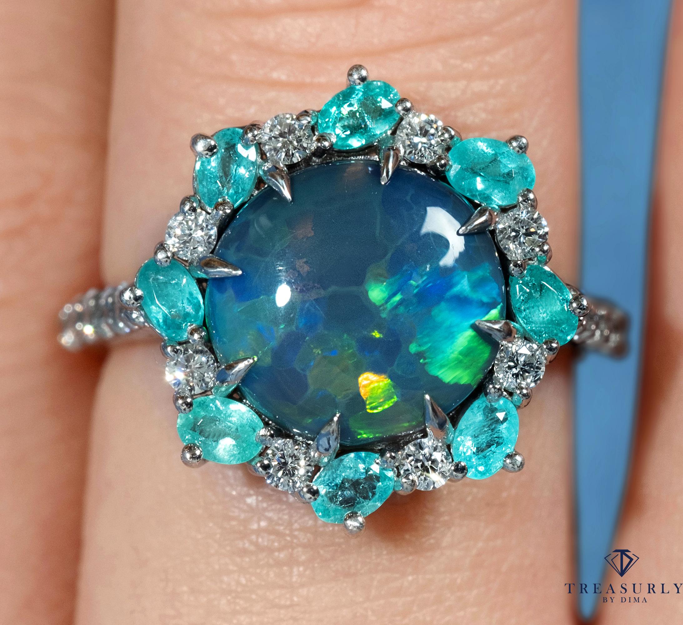 An Exquisite and Very Elegant Australian BLACK OPAL from the Lighting Ridge Mine, PARAIBA TOURMALINE and Diamond Cluster Platinum Ring.

Highly collectible the Center Opal is 2.55ct, measures 10.2 x 9.9 x 3.9mm. Body Tone 2N, Brilliance 4 on the