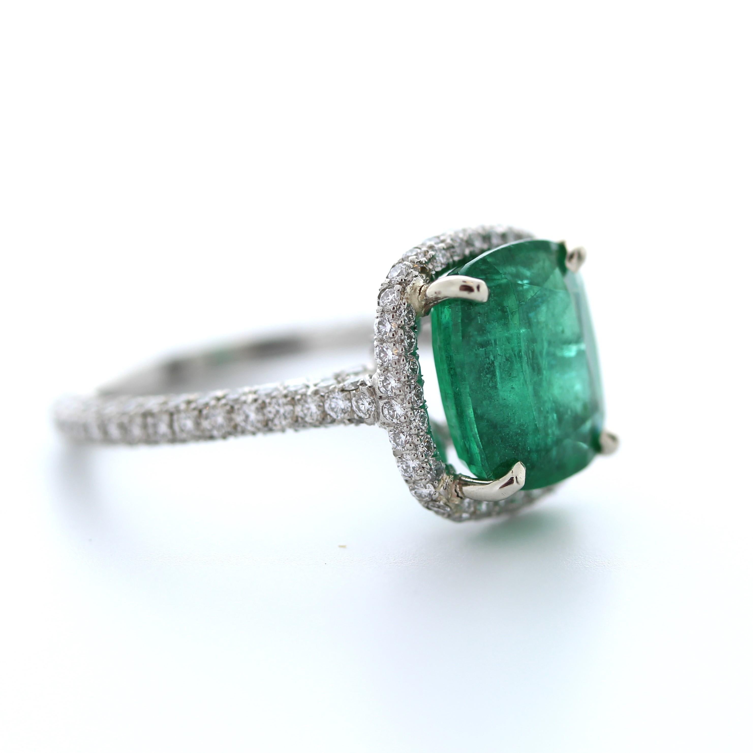 The 3.69 Carat Green Emerald Cushion Shape & Diamond Ring in Platinum is a magnificent piece of jewelry that features a stunning green emerald as its centerpiece. The emerald is a cushion-cut shape, which gives it a classic and timeless look. The