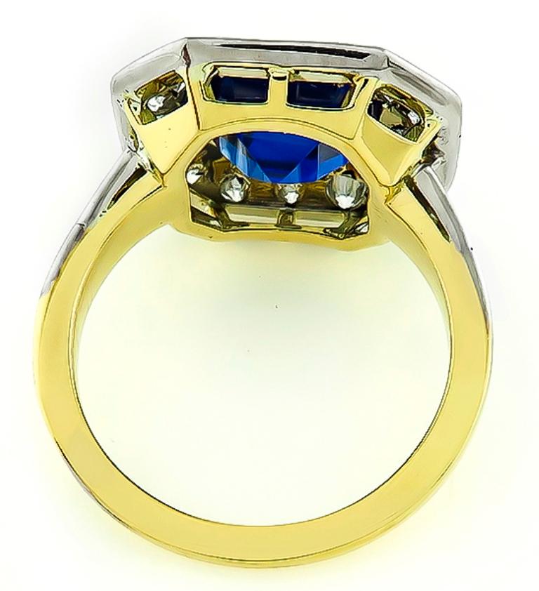 This fabulous 18k yellow and white gold engagement ring is centered with a lovely asscher cut sapphire that weighs 3.69ct. The sapphire is accentuated by sparkling round cut diamonds that weigh approximately 1.25ct. graded F-G color with VS clarity.