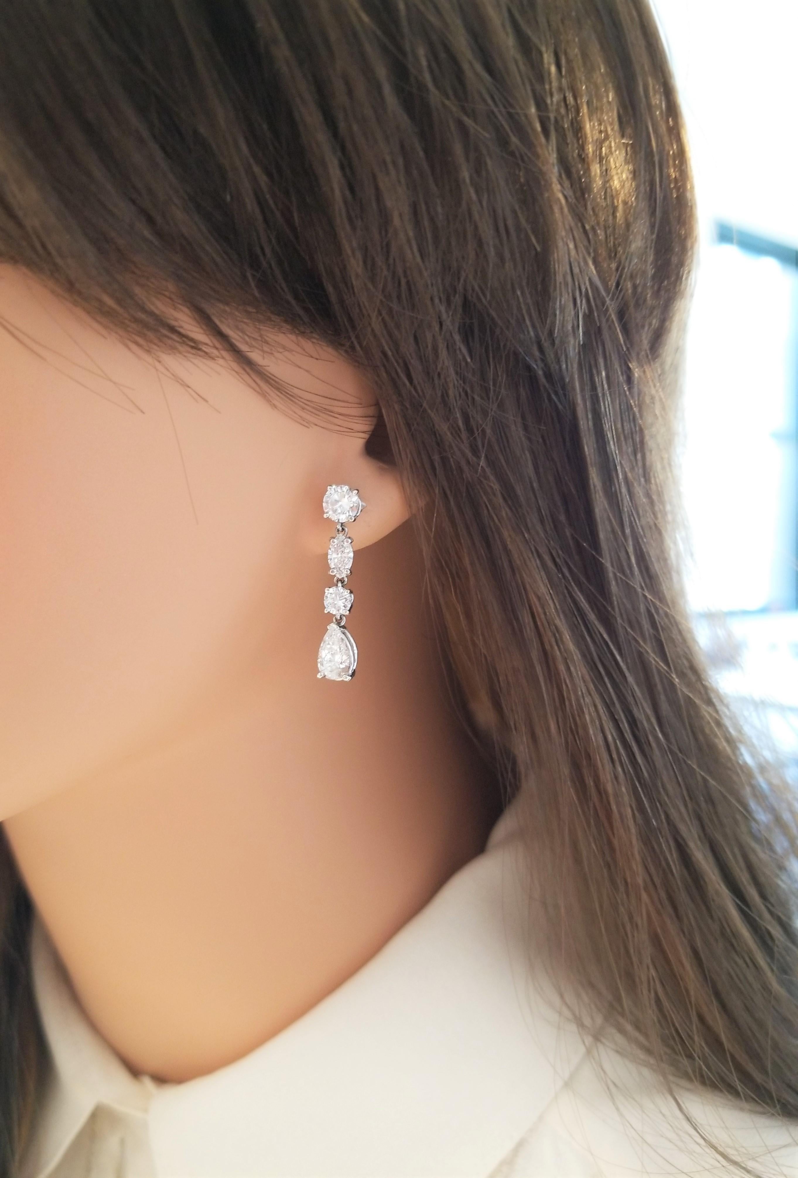 These are an incredible piece of diamond dangle earrings! 14 Karat white gold is the enduring metal that holds an attractive trio of diamond shapes. These stunning earrings feature round cut diamonds, marquise cut diamonds, and finishing with