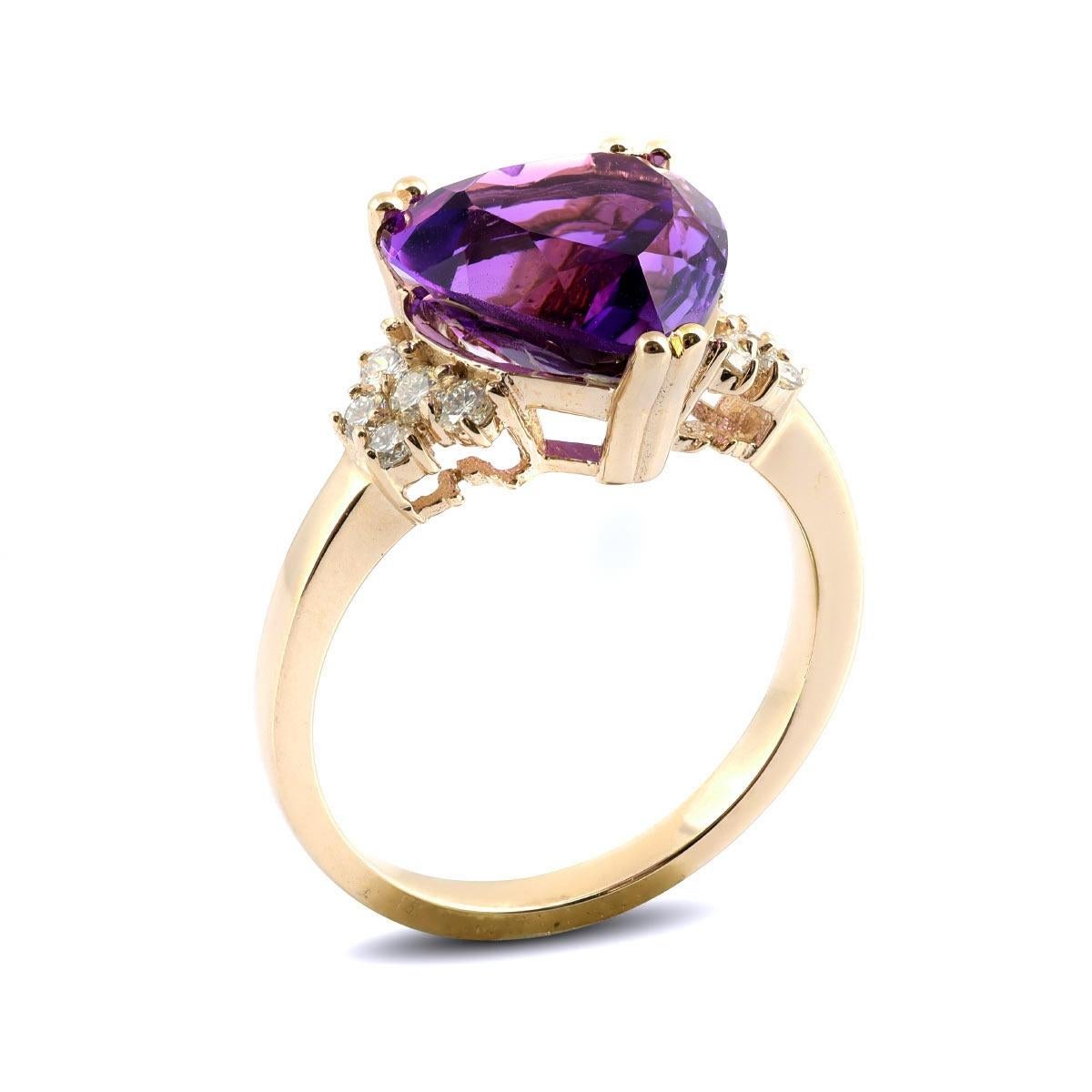Here is an Amethyst ring you will love. Set with a natural gem that has the most exotic purple hues, it comes together with the 14K yellow gold holding the gems in place. Paired with immaculate diamonds that accentuate the ring on either side there