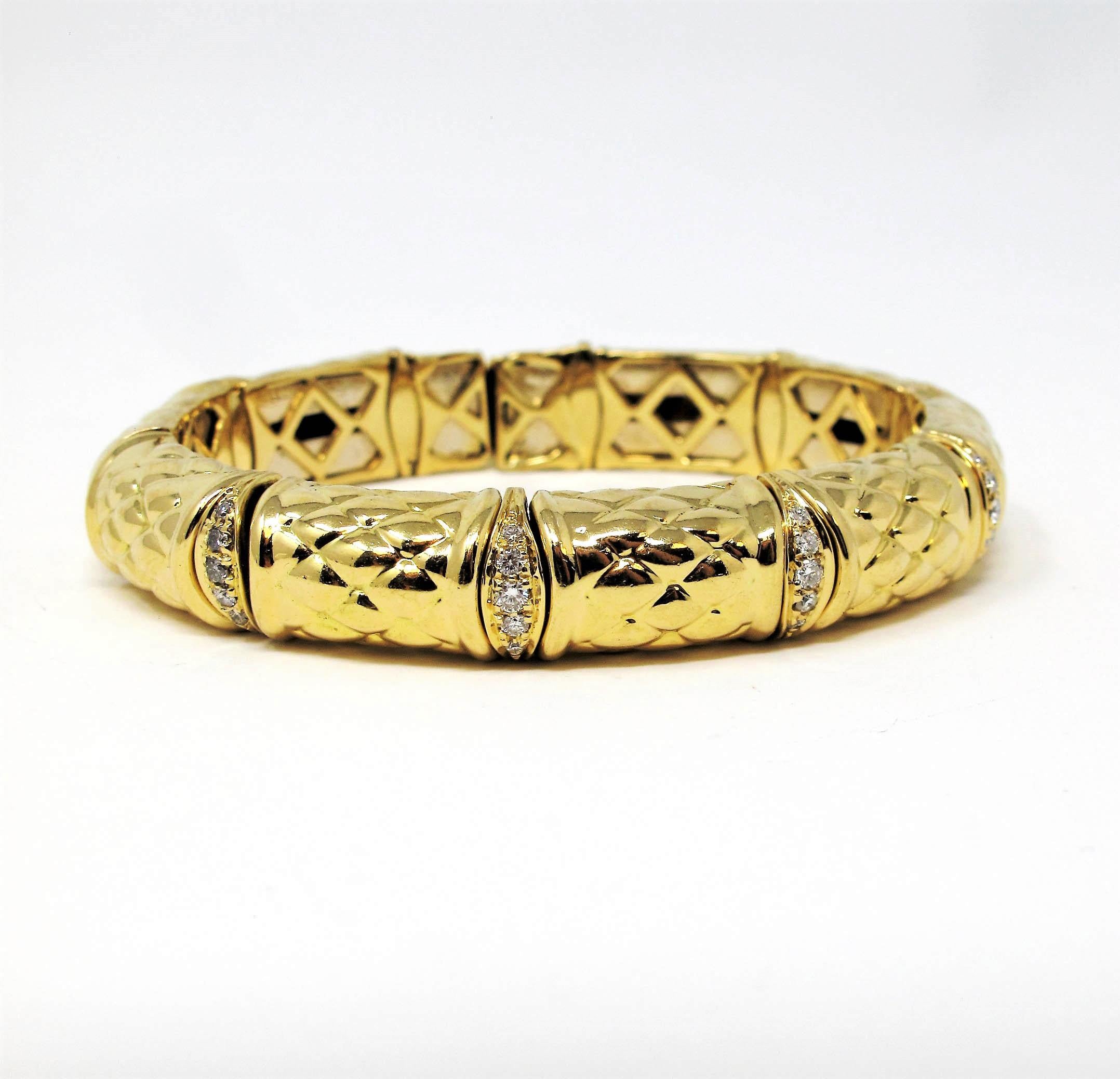 Gorgeous textured 18 karat yellow gold bangle bracelet with pave diamond accents. This incredible bracelet offers both comfort and style with its unique flexible bamboo style design. The subtle diamond embellishments add just a hint of understated