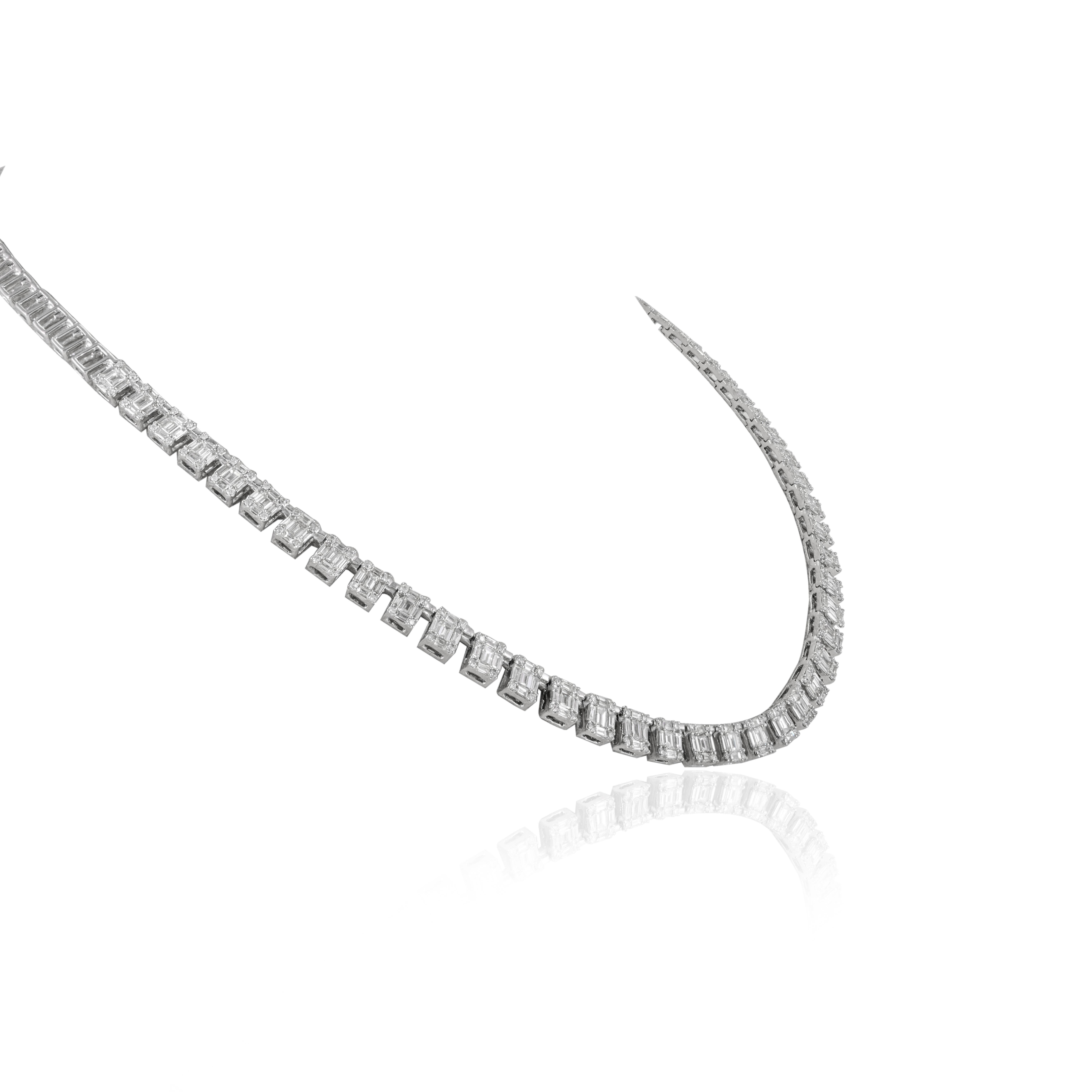 Emerald Cut Illusion Set Diamond Tennis Necklace studded in 18K Gold. This stunning piece of jewelry instantly elevates a casual look or dressy outfit. 
April birthstone diamond brings love, fame, success and prosperity.
Designed with mixed cut