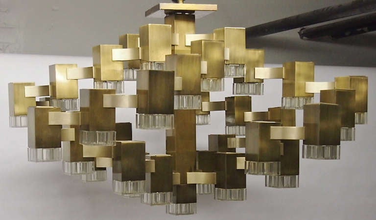 Large cubic ceiling fixture designed by Gaetano Sciolari and made by Lightolier in patinated brass plated steel with 37 lights that are connected by arched, brass finished, brushed aluminum arms. Each light has a single candelabra socket and a