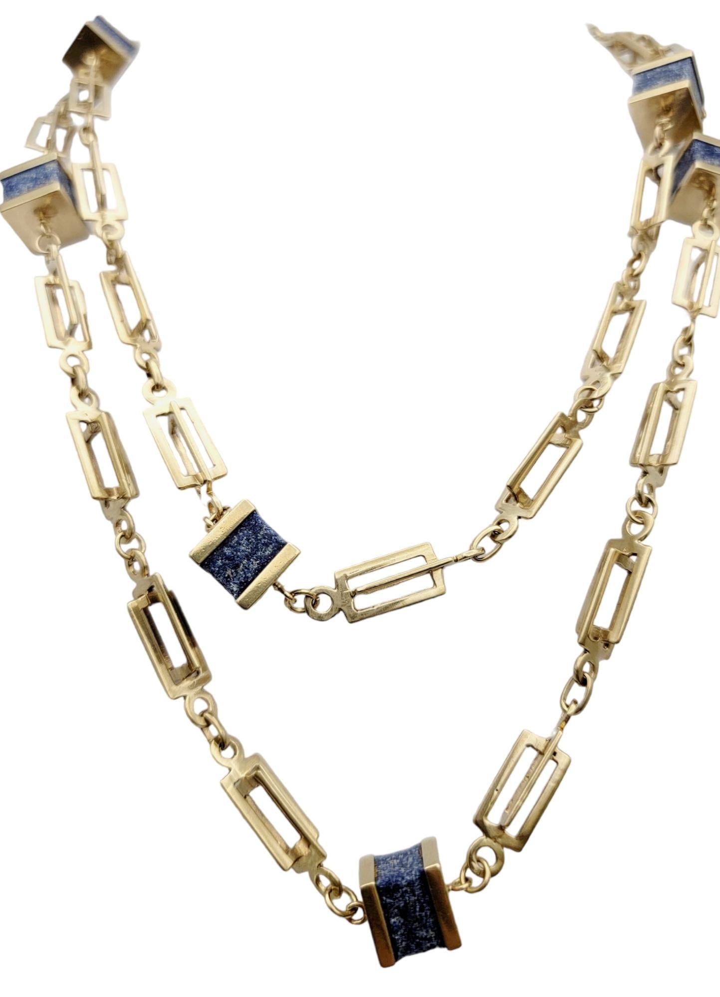 Contemporary elongated gold station necklace with natural lapis lazuli stones throughout. Long and luxurious, this modern necklace is a unique and fashionable piece you will wear again and again. 
 
This eye-catching necklace features a polished 14