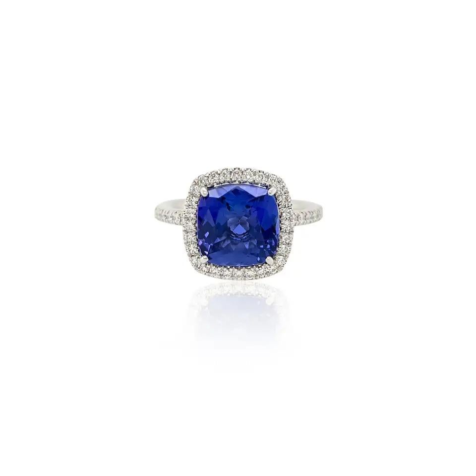 

This magnificent handmade 3.70ct natural cushion cut tanzanite and diamond ring features a vivid cushion cut tanzanite gemstone set in a luxurious 18k white gold setting. The eye clean cushion cut tanzanite is highlighted by dazzling white