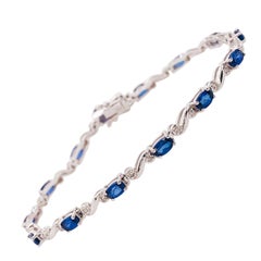 3.70 Carat Oval Blue Sapphire and Round Diamond Tennis Bracelet in 14 Karat Gold