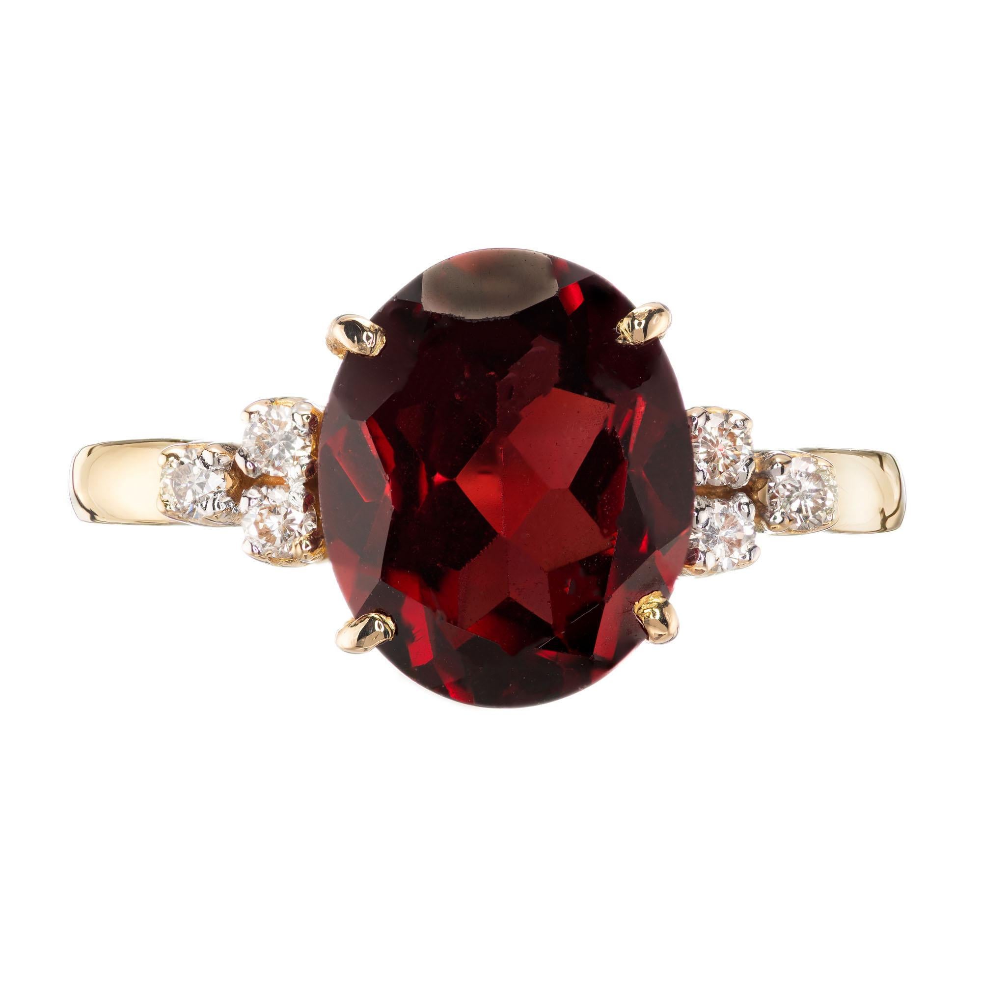 Reddish brown 3.70 carat garnet and 8 round accent diamonds in an 18k yellow gold setting. 

1 oval cut reddish brown garnet, VS approx. 3.70cts
8 round brilliant cut diamonds, I-J VS approx. .10cts
Size 7 and sizable
18k yellow gold 
Stamped: