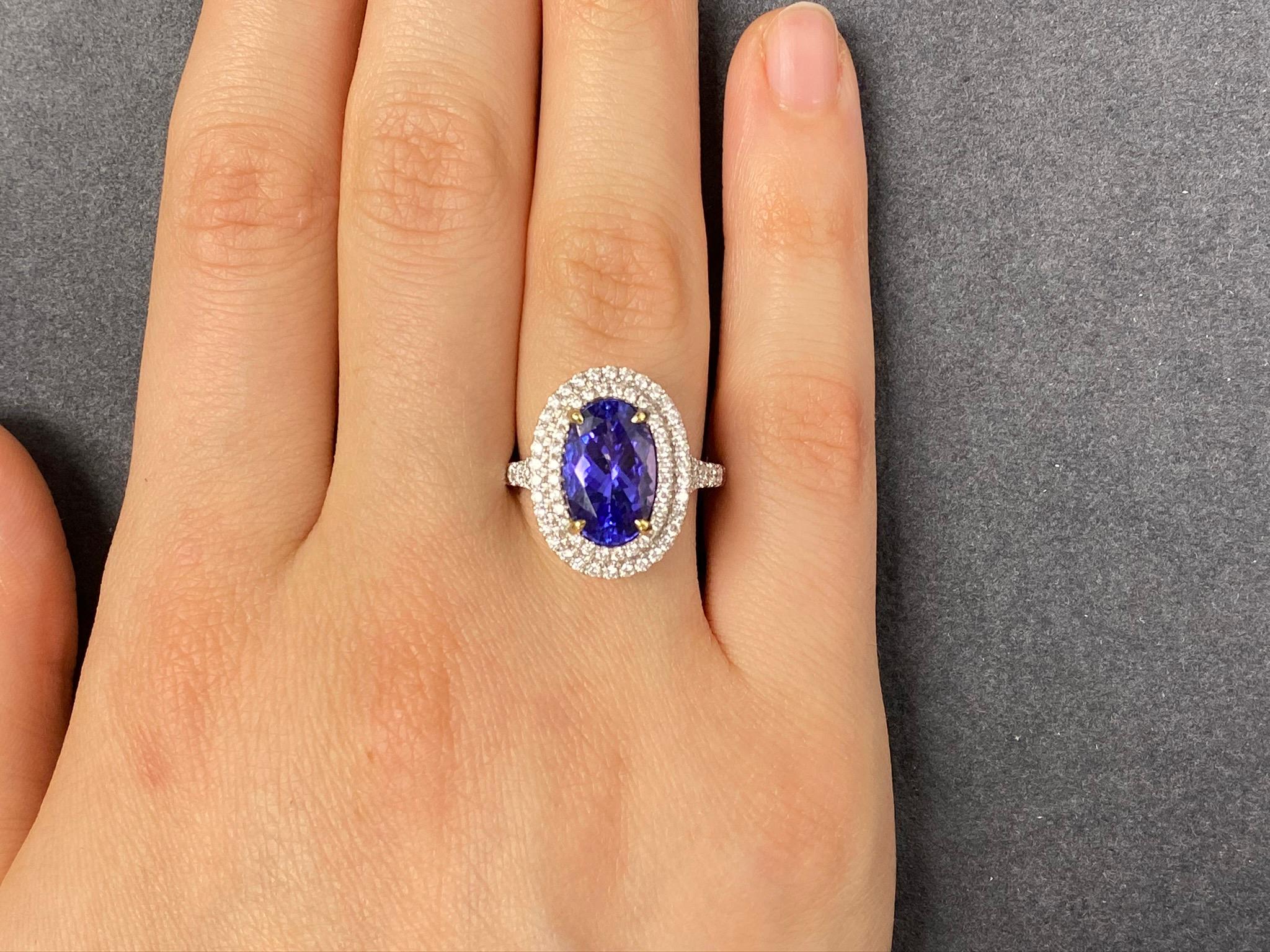 This beautiful cocktail ring features a stunning 3.70 Carat Oval Tanzanite with a Double Diamond Halo, that sits on a split Diamond Shank. This Ring is set in 18k White Gold, with 18k Yellow Gold prongs on the center stone. Total Diamond Weight =
