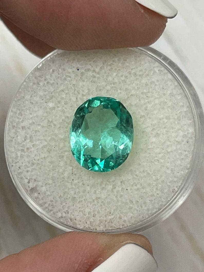 Stone: Emerald
Weight: 3.70-carats
Shape: Oval Cut
Clarity: Transparent
Luster: Excellent
Color: Light Bluish Green
Measurements: 10.82mm x 9.16mm x 6.24mm
Geographic Origin: Colombia
Treatment: Natural, Oiling

Comments: Due to their growth