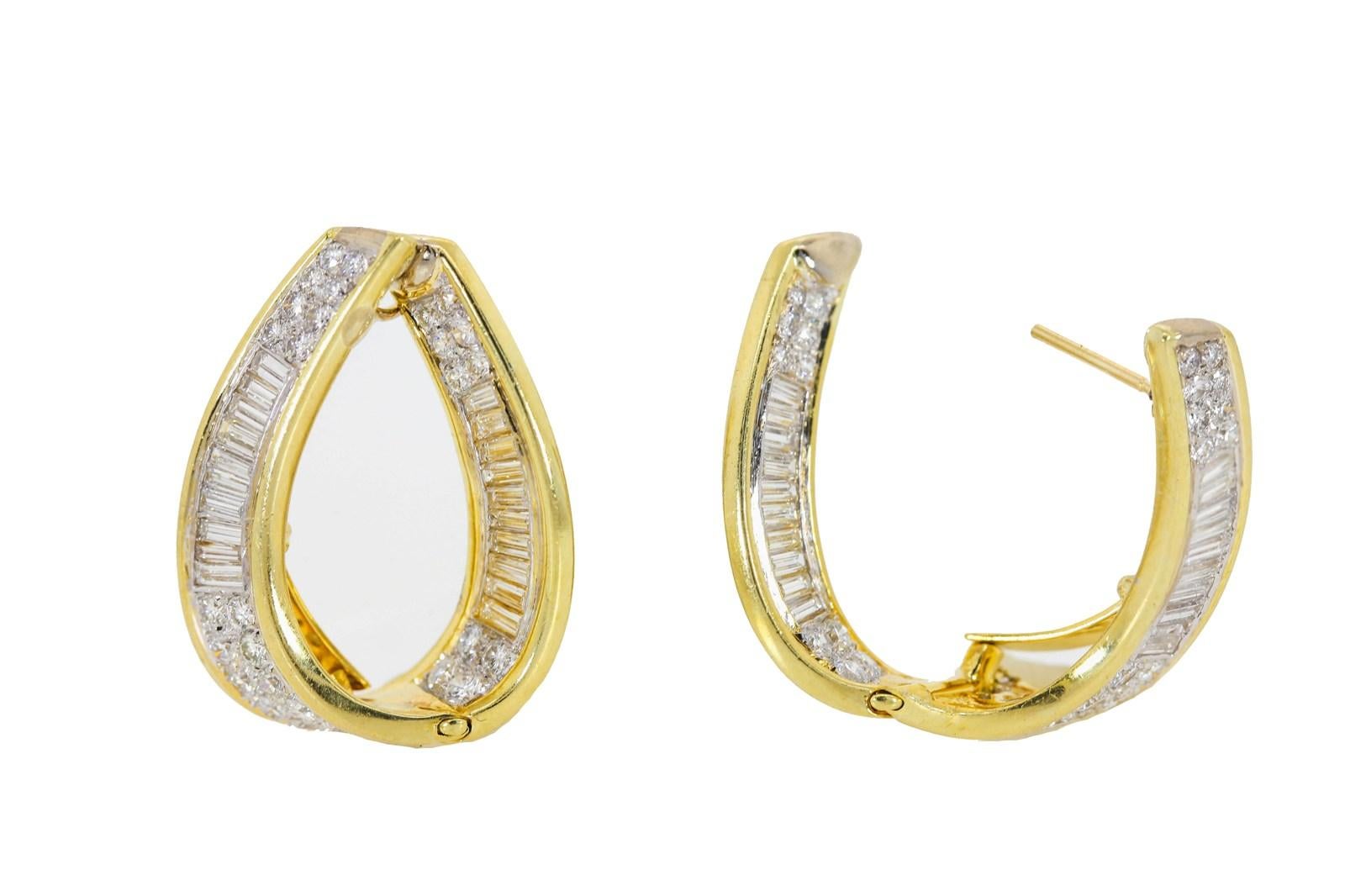 These two sided 18KT gold hoops are set with a medley of Baguette and Round Brilliant Cut Diamonds, giving a total of 3.70 carats.  The diamonds are H/I color - VS clarity and show brilliantly from all angles.  High quality craftsmanship!