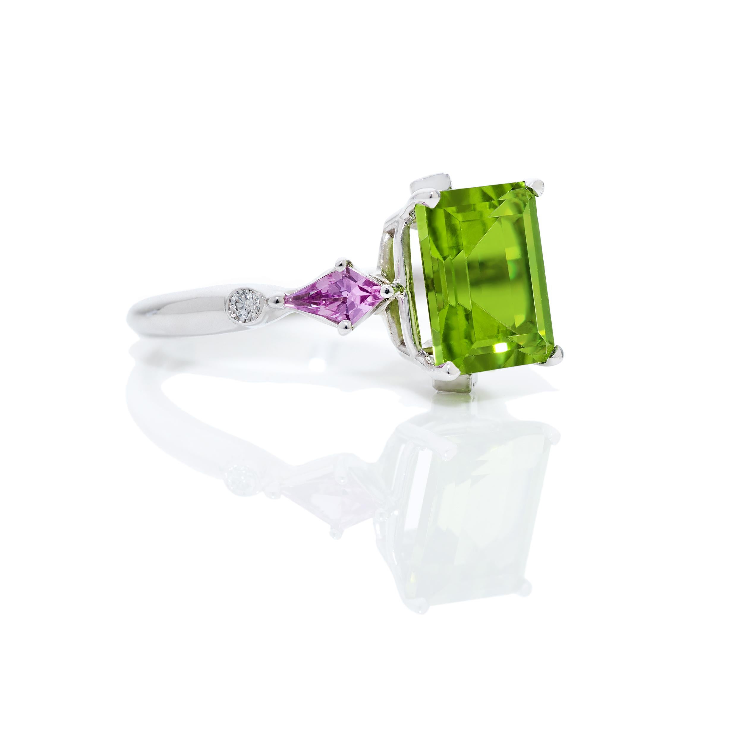 A precious ring designed alongside a coordinating necklace and earrings that can be found in separate listings.

The Emerald Cut Peridot is the main feature of this ring.  It's the subtitles of the detail of this ring that make it so special.  On