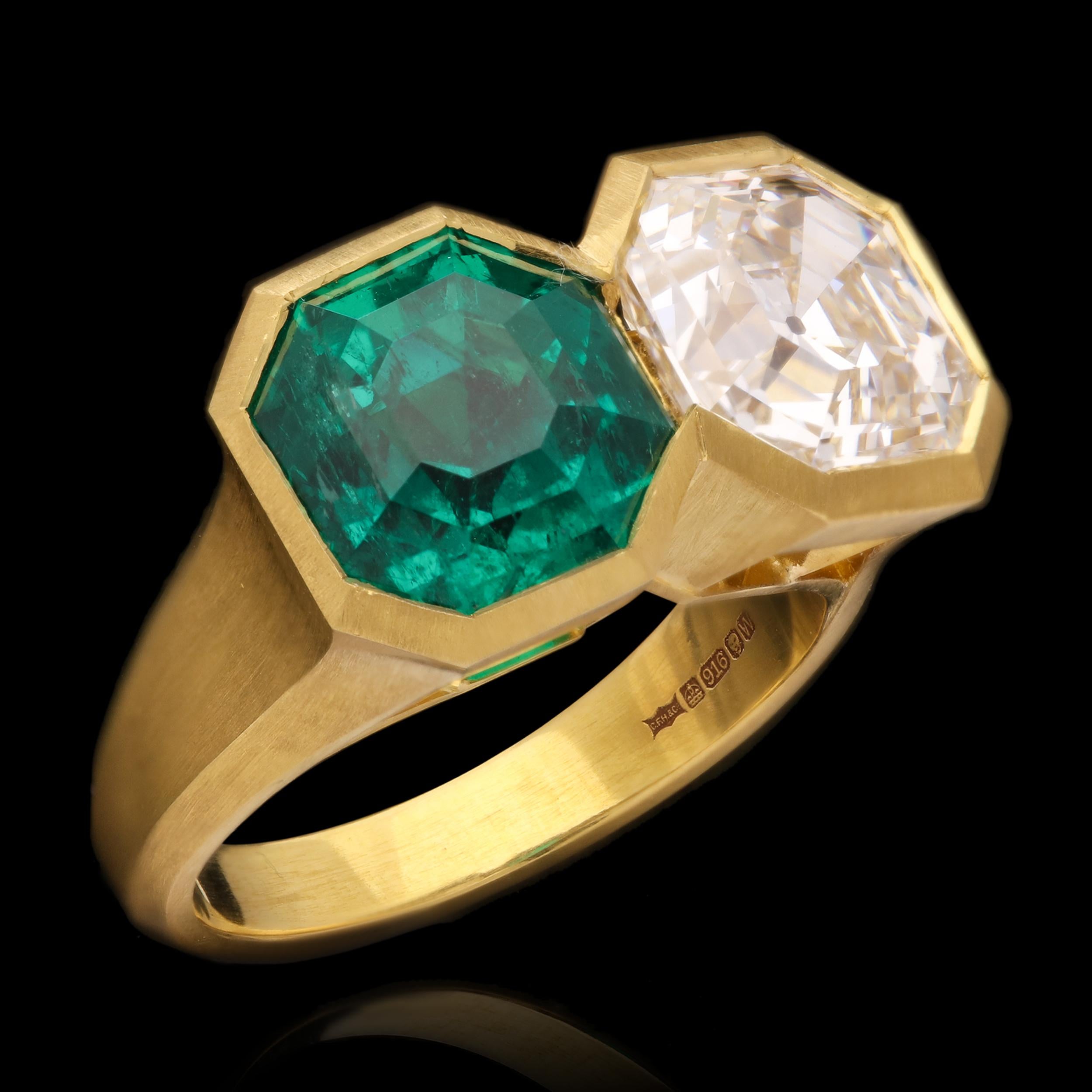 A stunning emerald and diamond two stone ring by Hancocks, set side by side with an Asscher cut diamond weighing 3.70ct and of F colour and SI1 clarity and an octagonal step cut Colombian emerald weighing 4.08ct, both in rubover settings with