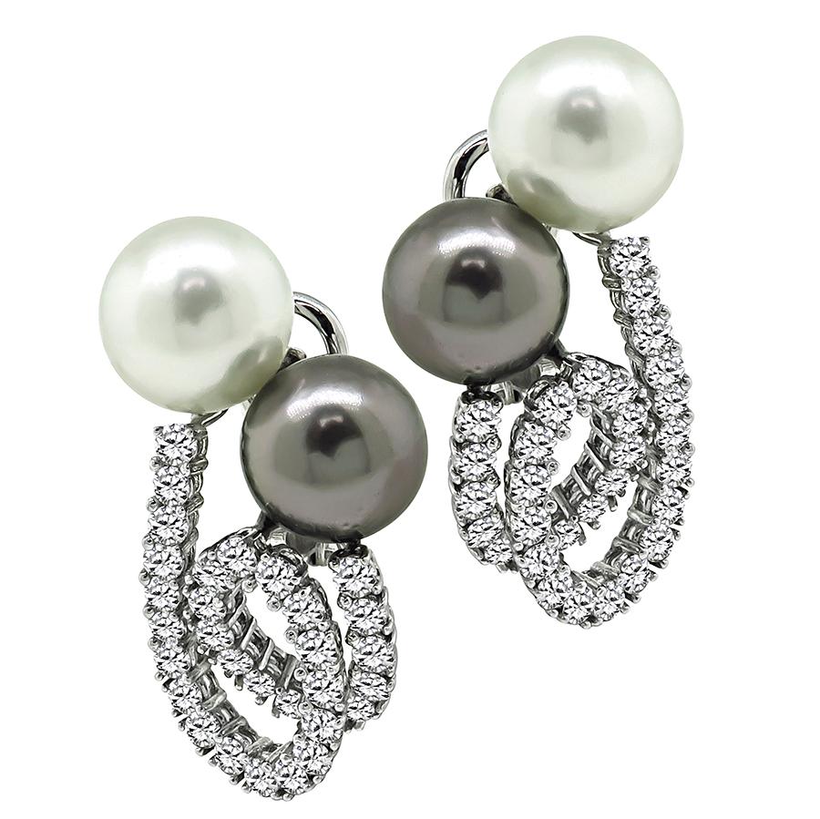 This is a stunning pair of 18k white gold and platinum earrings. The earrings feature sparkling round cut diamonds that weigh approximately 3.70ct. The color of these diamonds is E-F with VS clarity. The diamonds are accentuated by lovely white and
