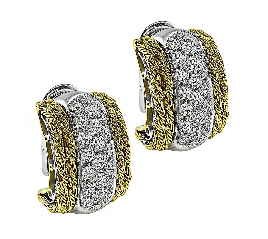 This is a fabulous pair of two tone 18k yellow and white gold earrings from the 1960s. The earrings feature sparkling round cut diamonds that weigh approximately 3.70ct. The color of these diamonds is G with VS clarity. The earrings measure 21mm by