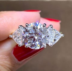3.70ct Round Brilliant Cut Center with 1.60ct t.w. 2 Trillion Cut Side Diamond E
