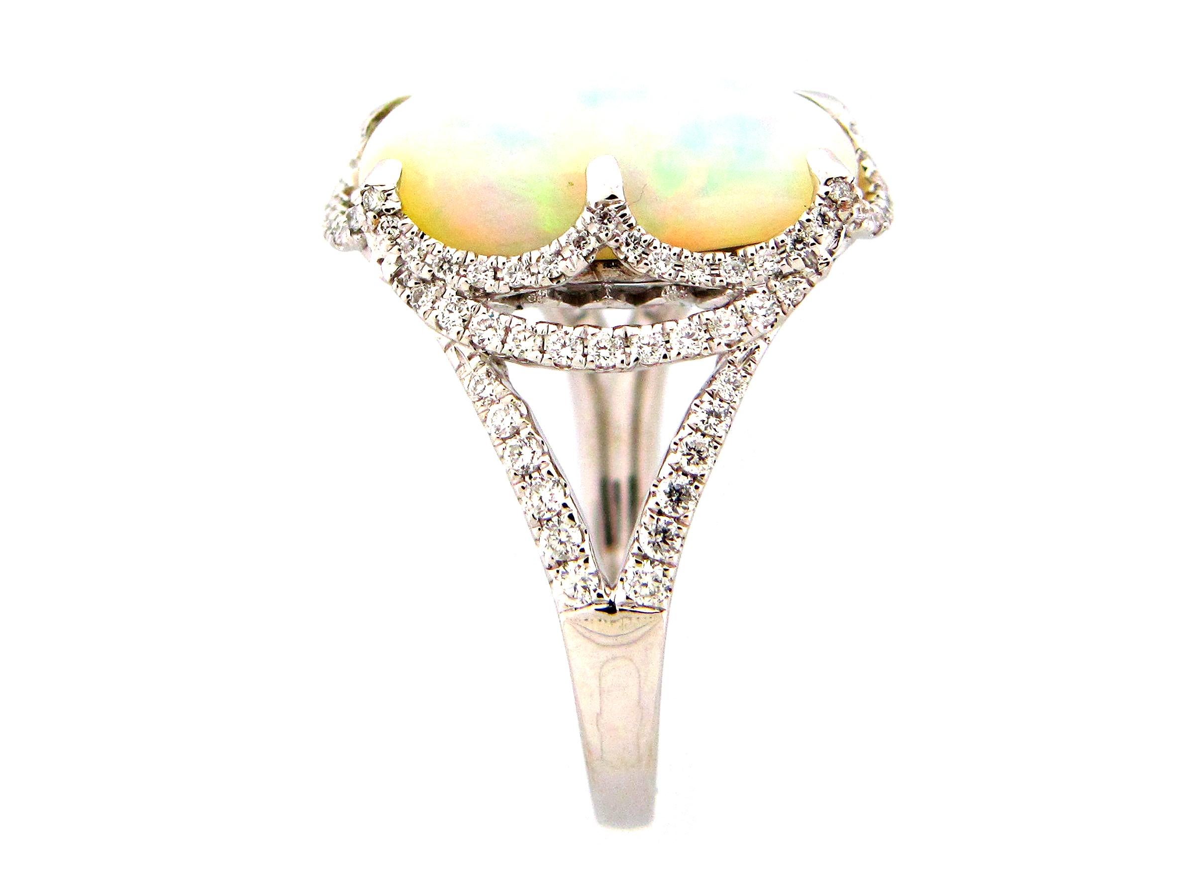 This stunning cocktail ring showcases a beautiful 3.71 Carat Cushion Ethiopian Opal with a Diamond Halo on a Diamond Shank. This ring is set in 18k White Gold. Total Diamond Weight = 0.46 Carats. Ring Size is 6 1/2.
