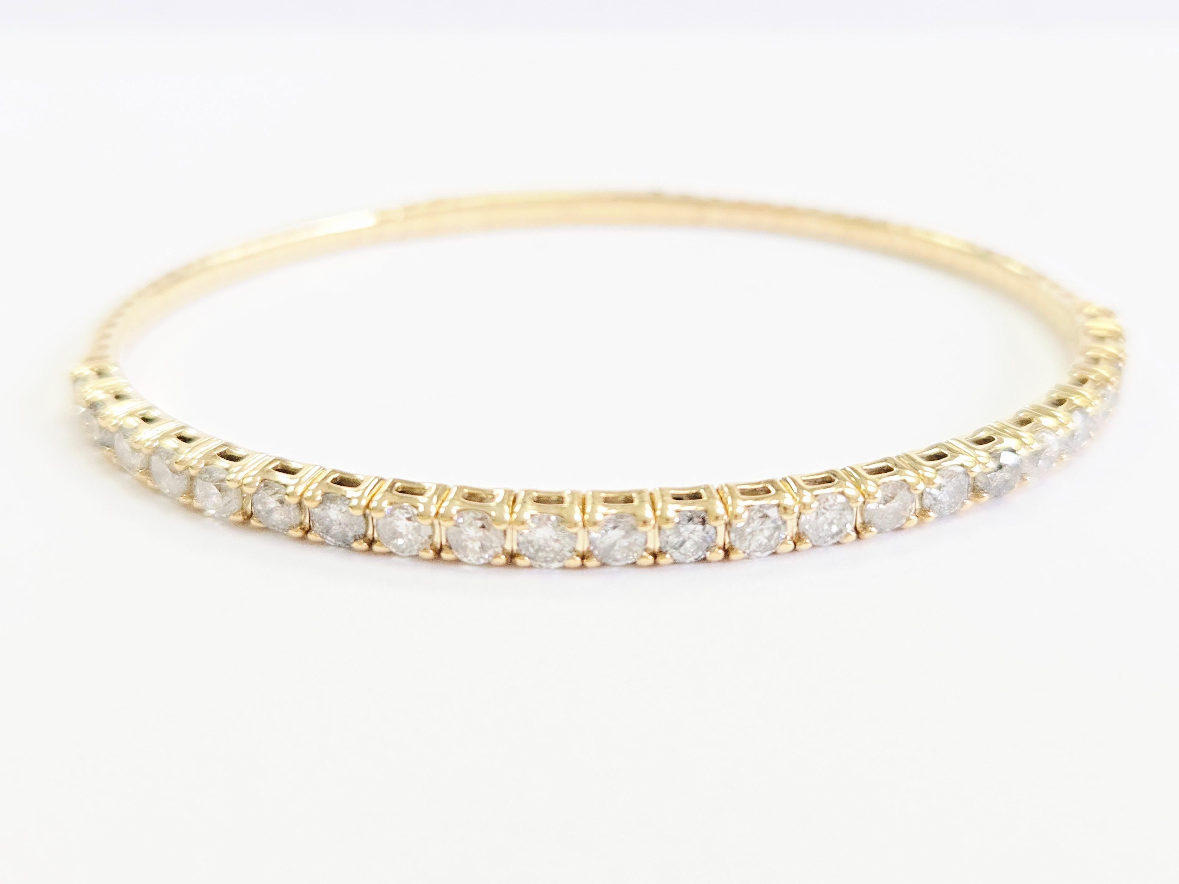 This 3.71 Carat Flexible Bangle is a stunning piece of jewelry that is designed with elegance and sophistication. 

Carat Weight: 3.71 cts, showcasing a significant amount of natural diamonds that are beautifully set half way around the