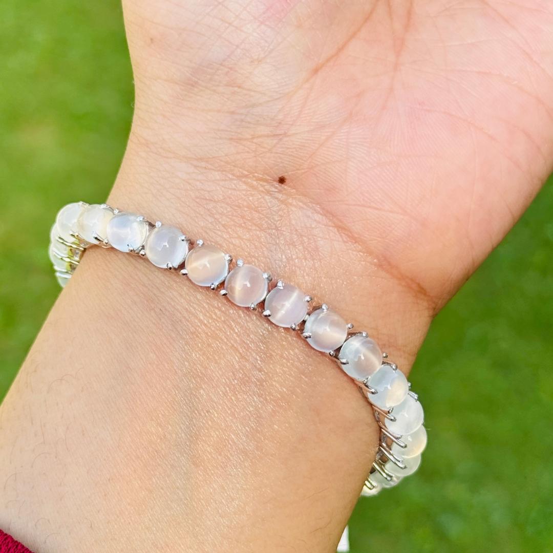 37.1 Carat Round Moonstone Tennis Bracelet in sterling silver showcases endlessly sparkling natural moonstone, weighing 37.1 carat. It measures 7.5 inches long in length. 
Moonstone stimulate concentration and reduces stress. 
Designed with perfect