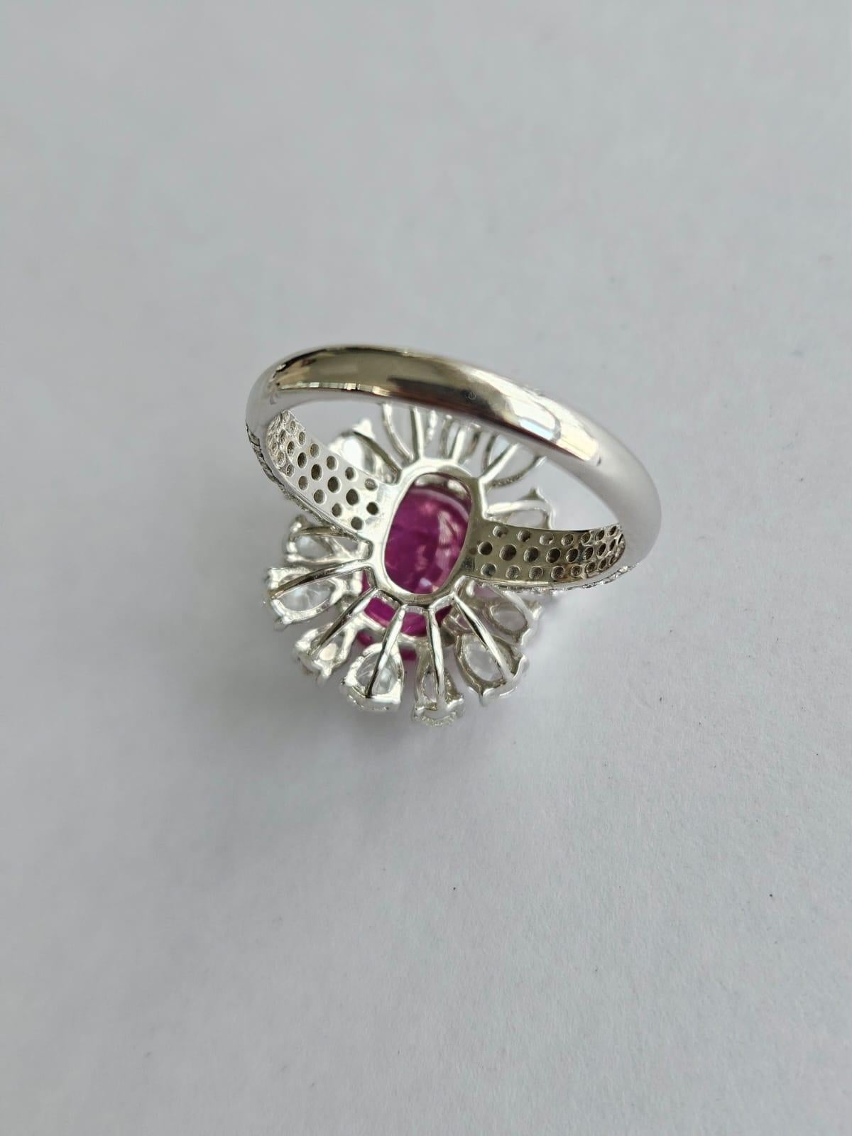 A very gorgeous and special, modern style, Ruby Engagement Ring set in 18K White Gold & Diamonds. The weight of the Ruby is 3.71 carats. The Ruby is completely natural, without any treatment & is of Burmese origin. The combined Diamonds weight is