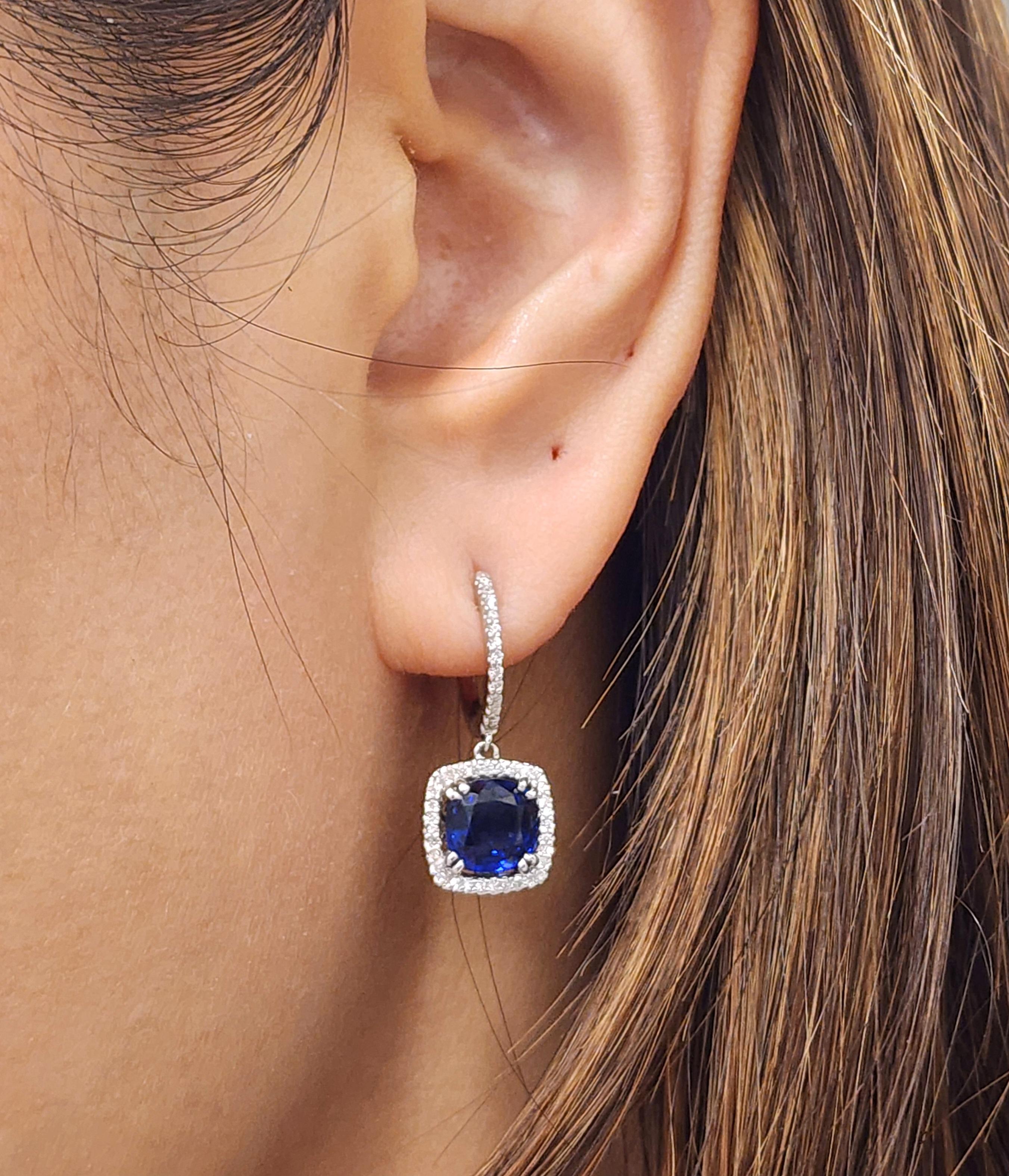 These gorgeous natural heat treated sapphires and diamond earrings will complete any wardrobe. 3.71 total carats, the diamonds surrounding the natural sapphire are a F/G in color with a VS2/SI1 in clarity.