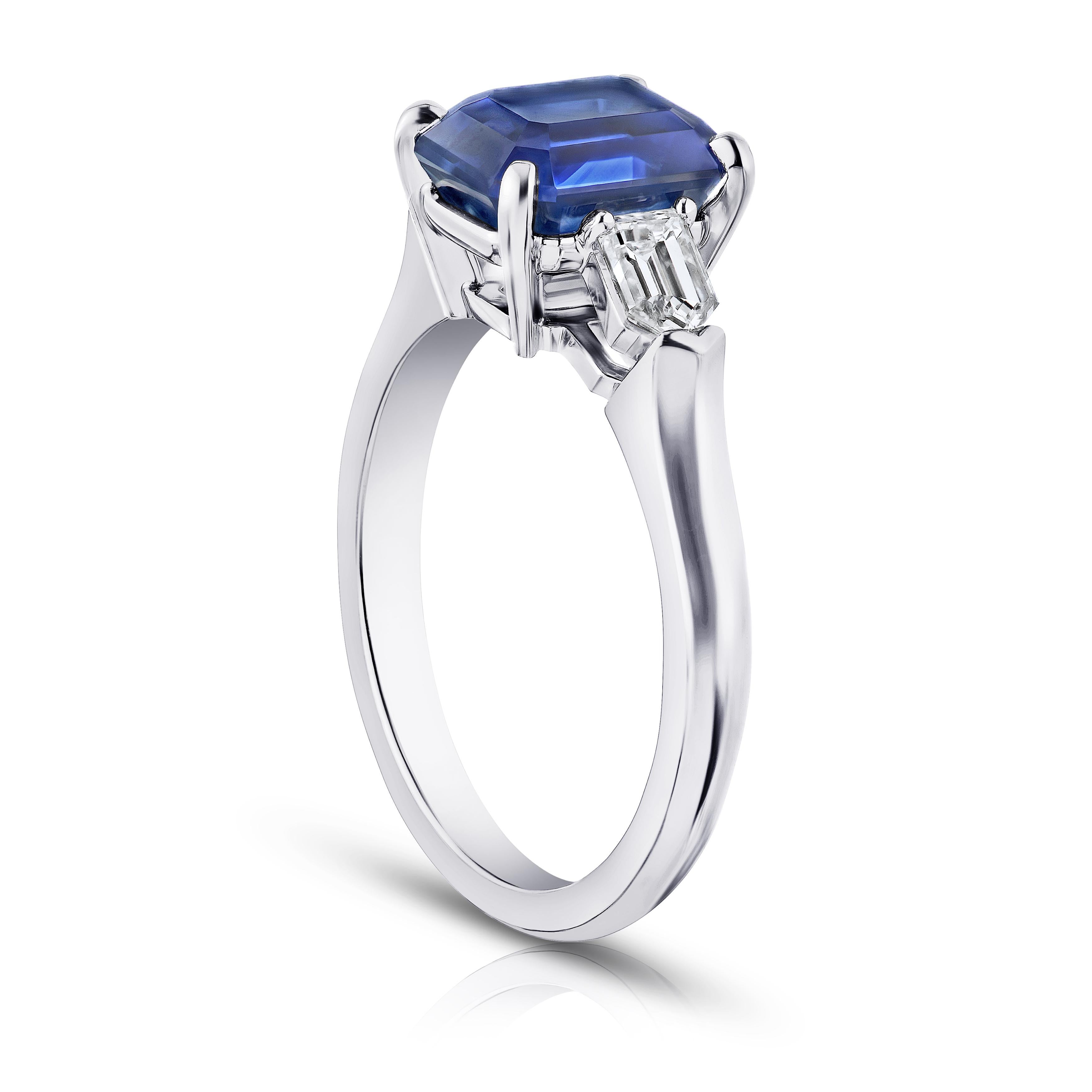 3.72 carat emerald cut blue sapphire with straight bullet diamonds .52 carats set in a platinum ring. This ring is currently a size 7.  We will resize to your finger size without charge.
