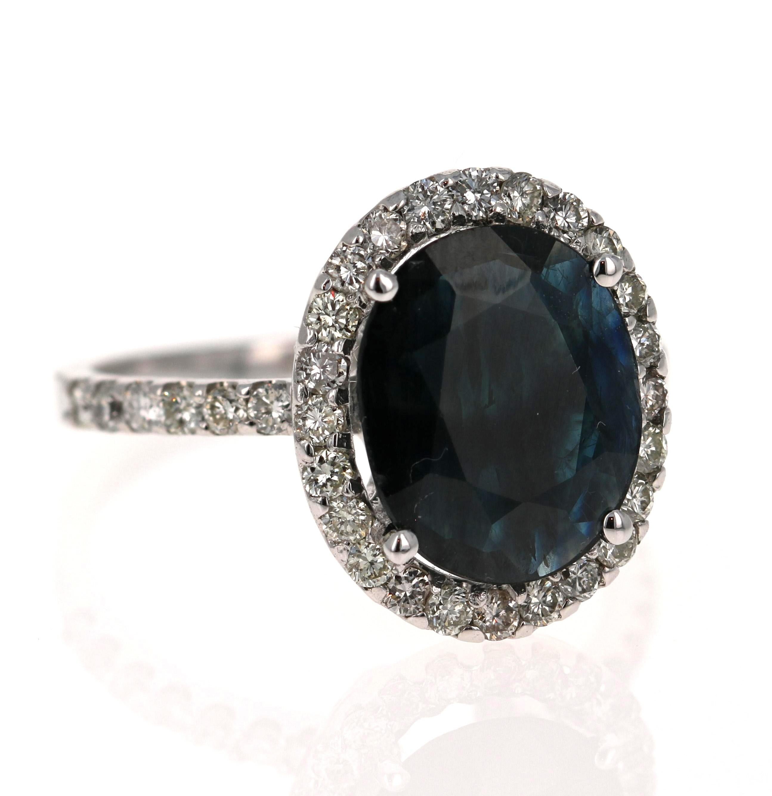 Gorgeous 3.72 Carat Sapphire and Diamond ring that can easily be worn as a unique Engagement ring!  

The Deep Midnight Blue Oval Cut Sapphire weighs 2.99 Carats and is surrounded by 38 Round Cut Diamonds that weigh 0.73 Carats.  The total carat