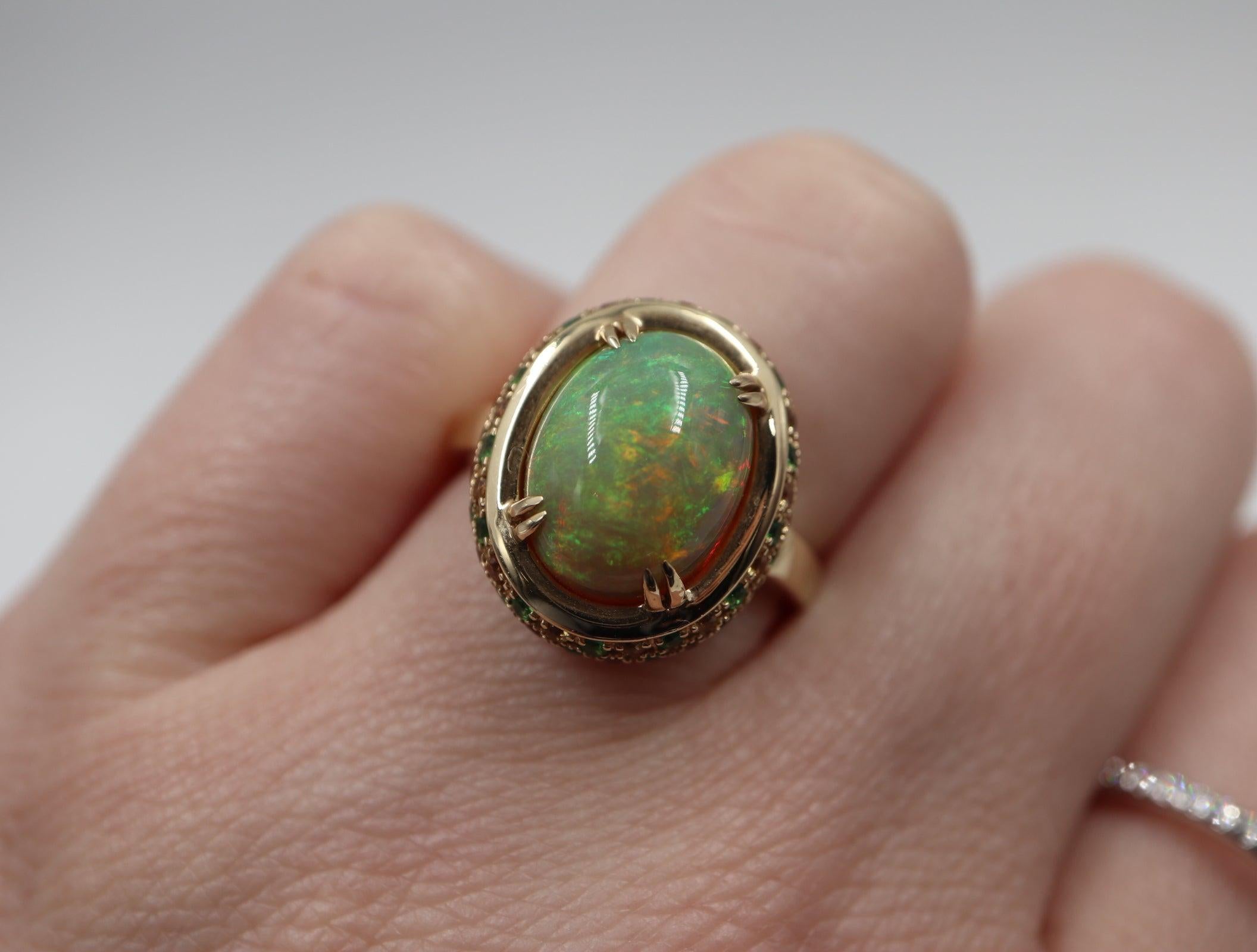 Designed in 14 karat yellow gold. This Ethiopian Opal Solitaire is surrounded by Tsavorite and Diamonds.
Opal: 3.72ctw
Diamond: 0.65ctw