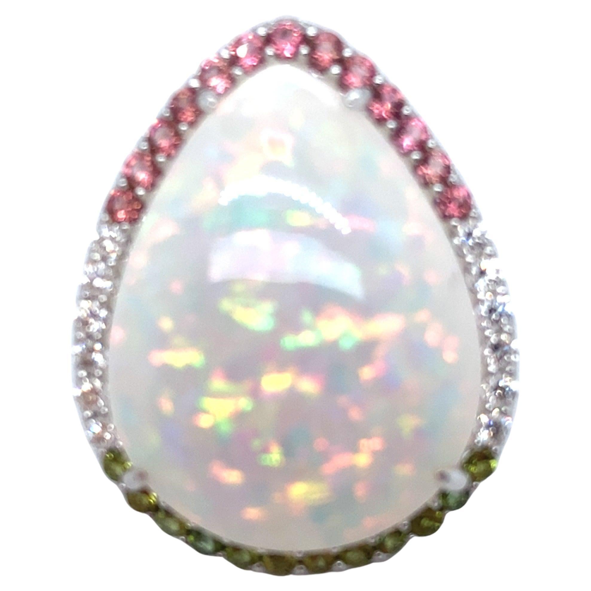 This exquisite 37.24-carat opal is elegantly encircled by a halo of 0.90 carats of sapphires and 0.46 carats of diamonds. The design features a beautifully crafted under-gallery and is set in luxurious 14k white gold, creating an exclusive and